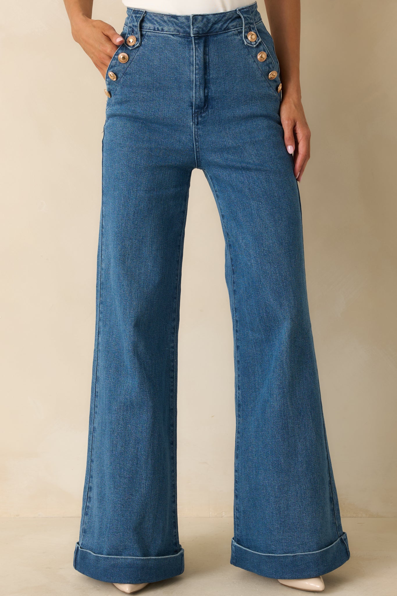 Wide-leg indigo jeans showcasing cuffed hems and a relaxed yet structured silhouette.