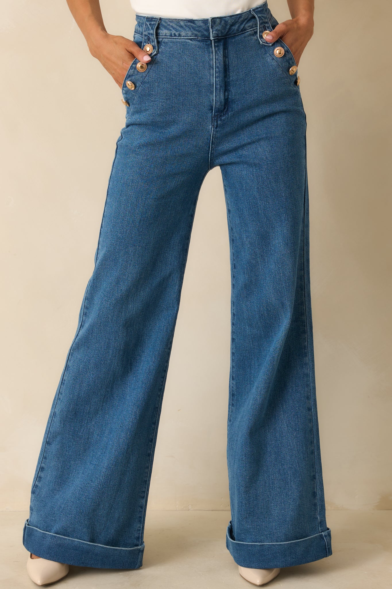 Cropped view highlighting the high waist and front seam detailing of the stretch denim.