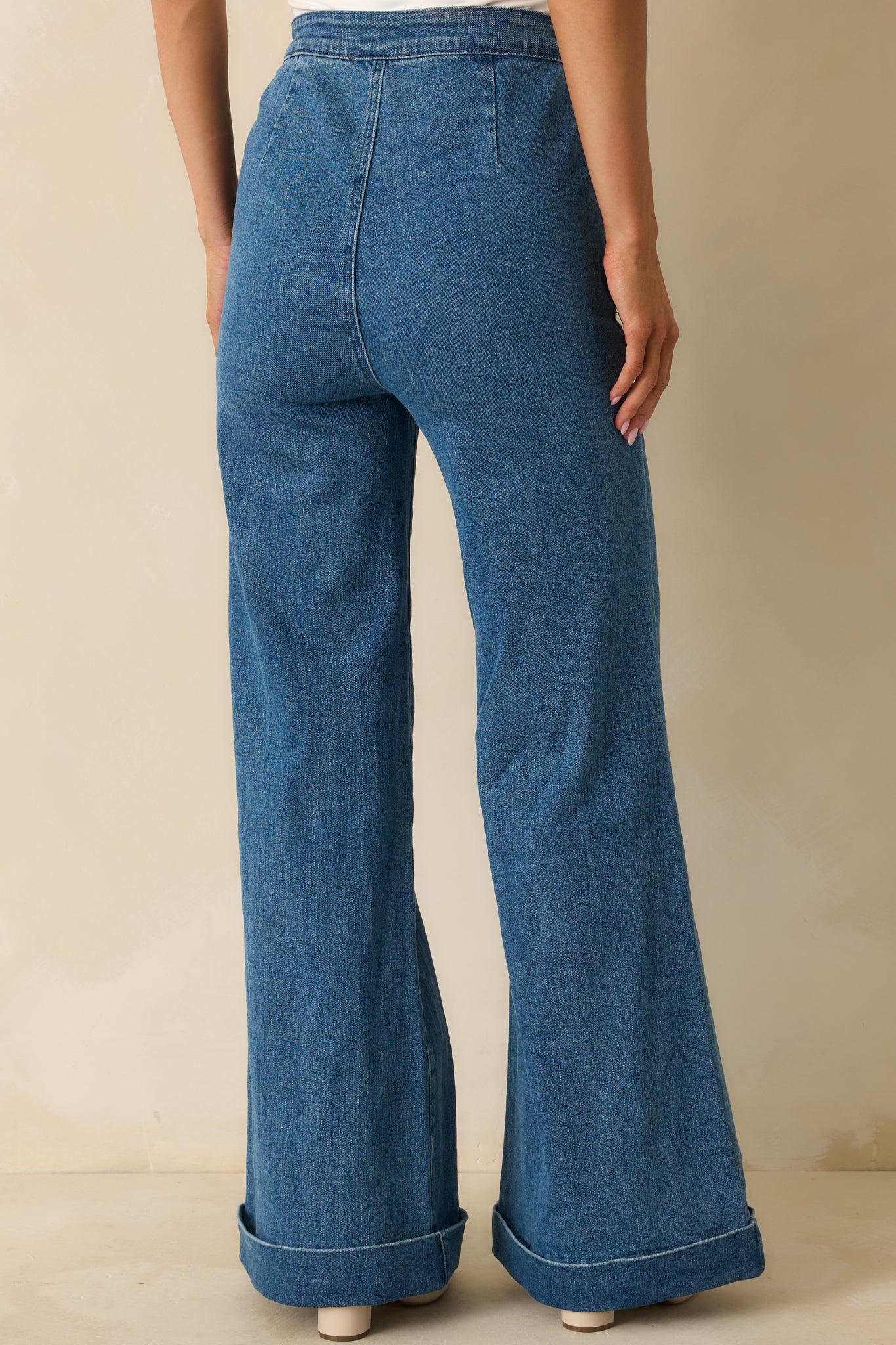 Rear view of the indigo wide-leg jeans displaying clean back pockets and full-length cuffs.