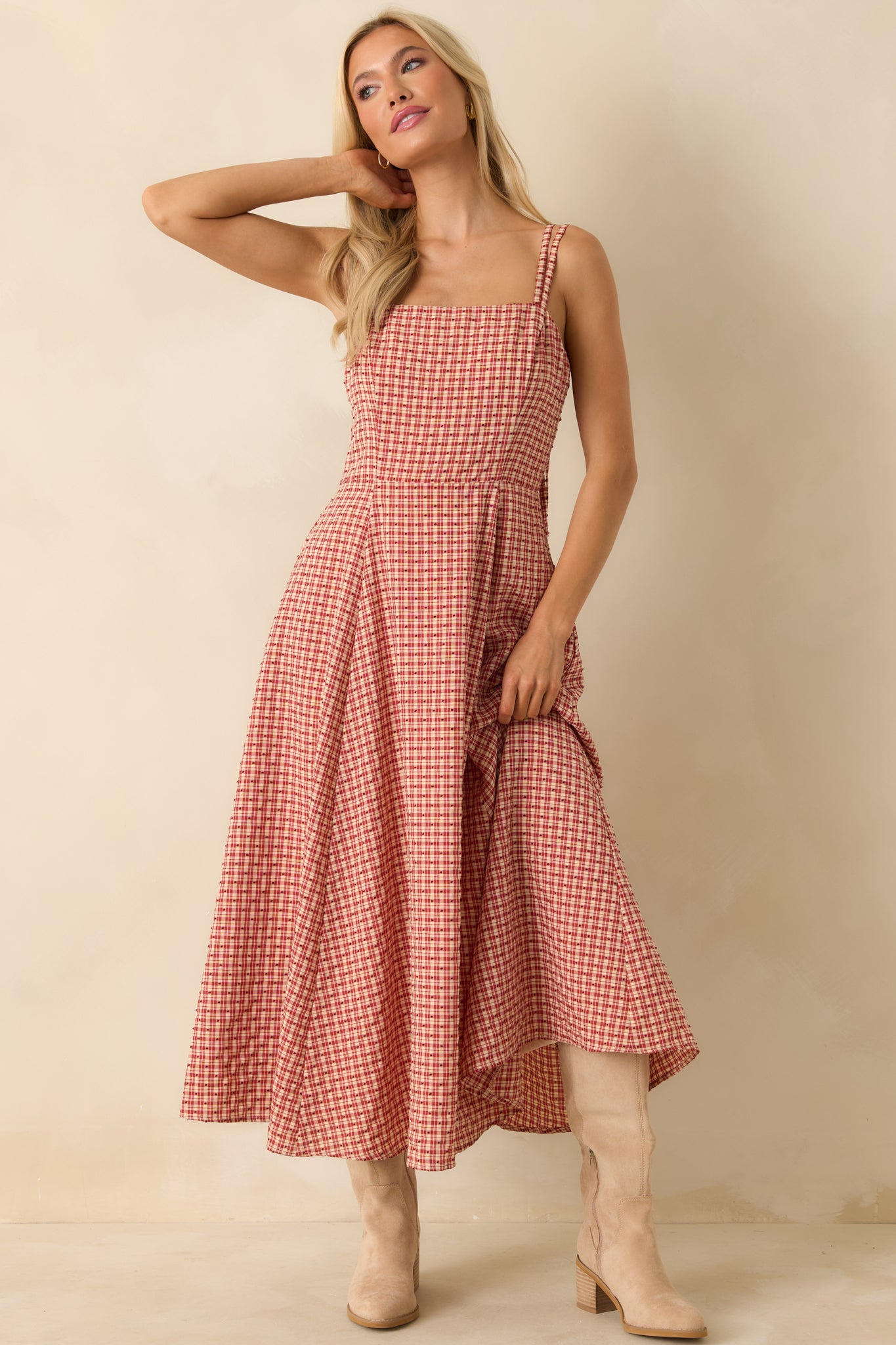Angled front view of red gingham maxi dress showing the textured polka dot embroidery and flowy full-length skirt.