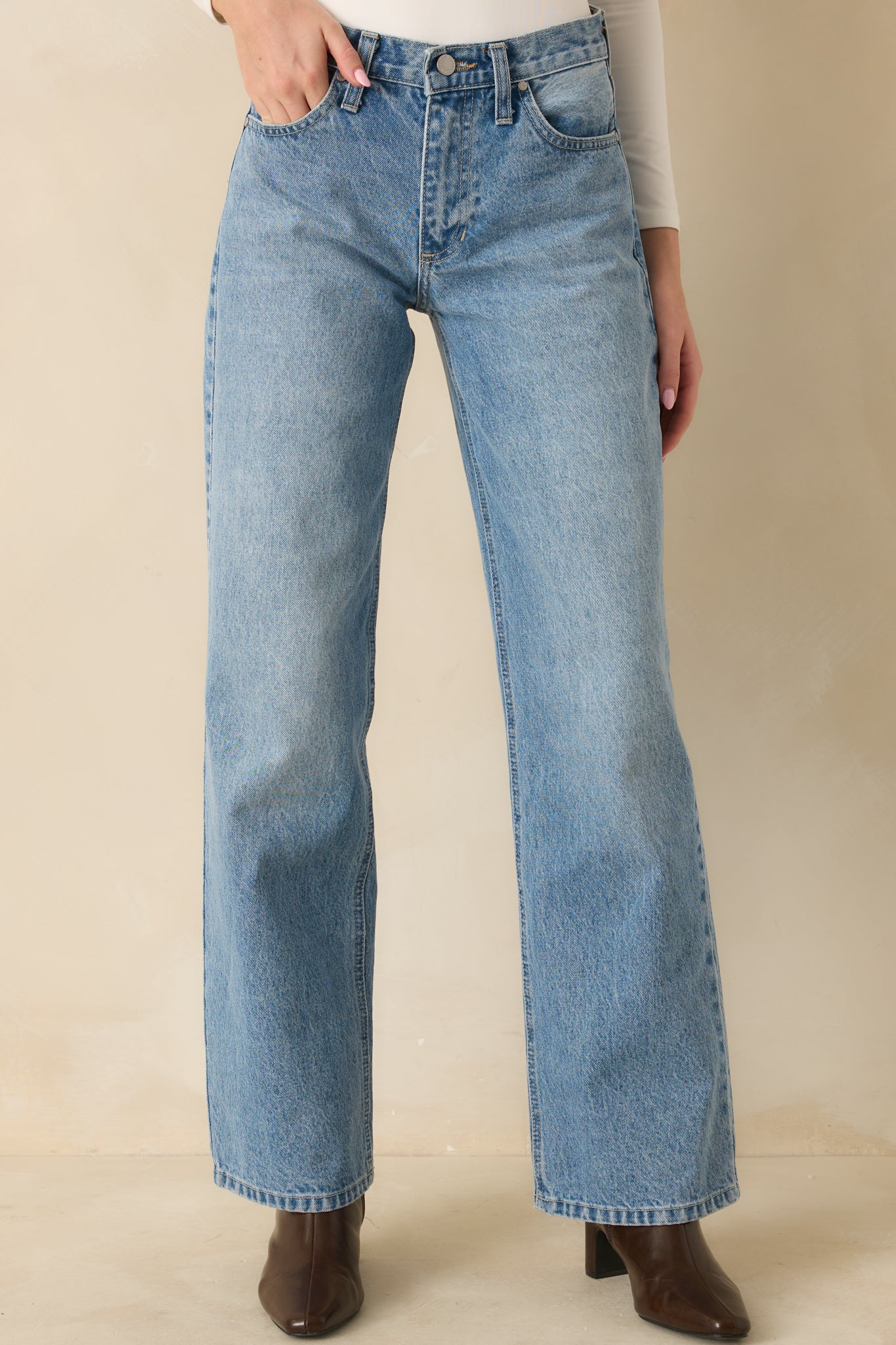 Close view of high waist and button & zip closure with relaxed front fit.