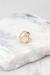 Back view of  a gold ring featuring a gold double loop design.
