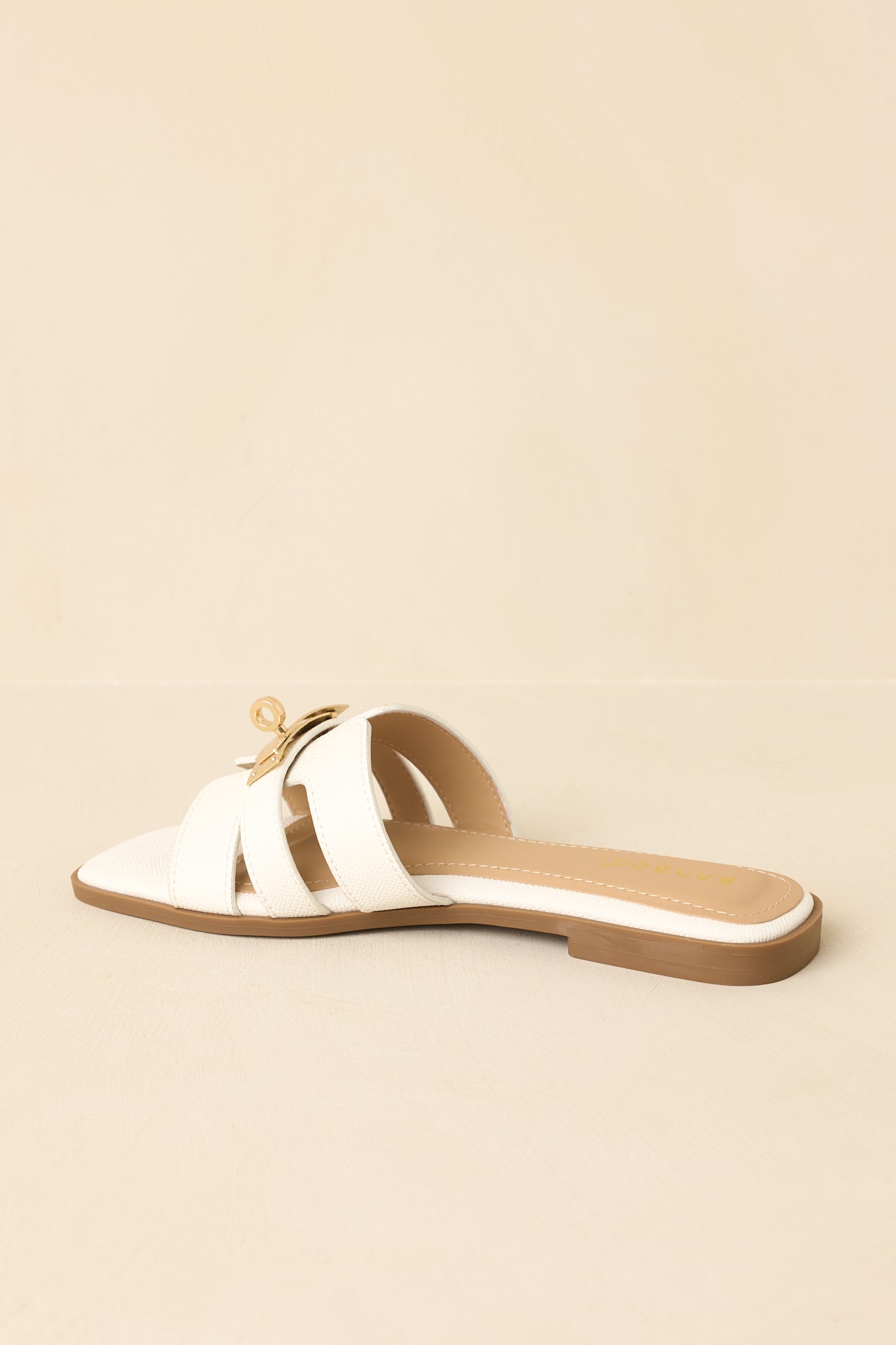 Slightly angled back view against neutral background emphasizing overall slide shape and comfort sole.