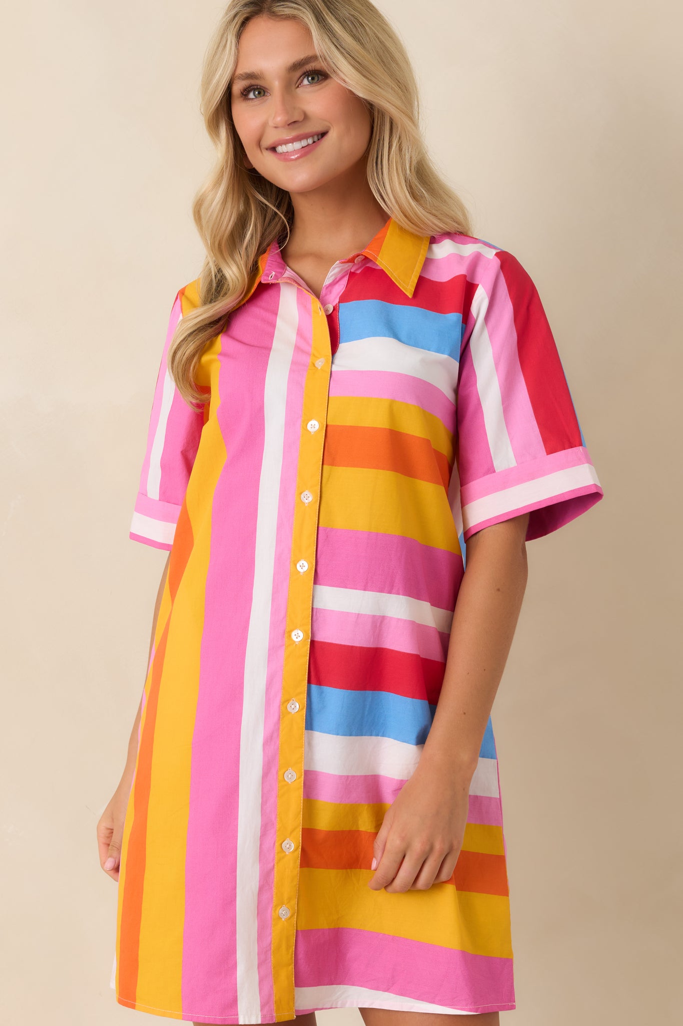 Close view of relaxed mini dress with cuffed sleeves and lightweight cotton striped fabric.