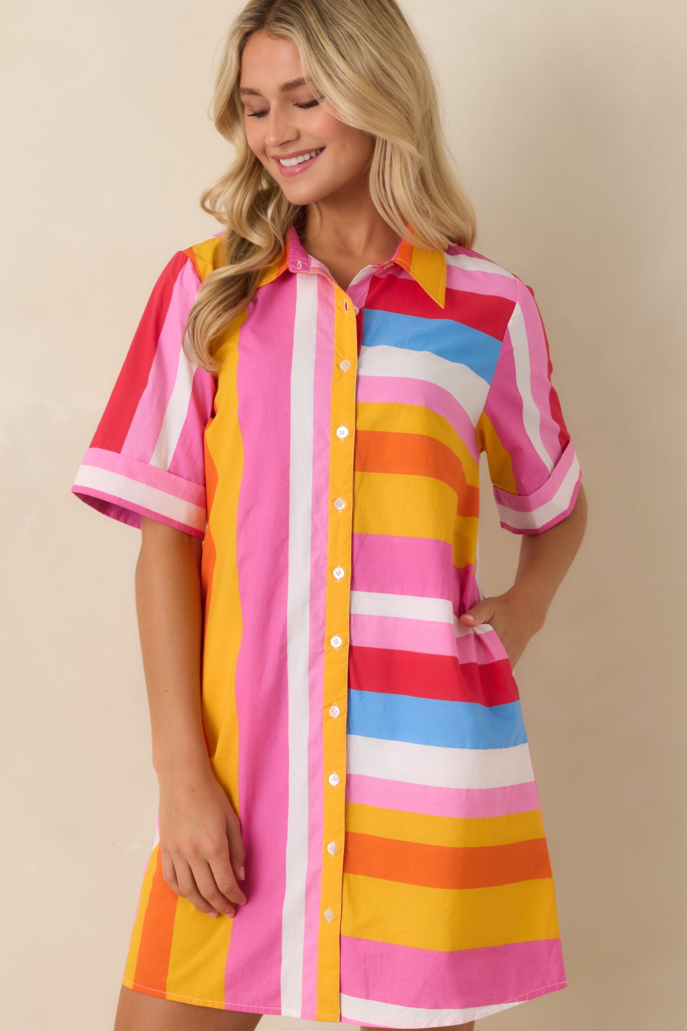 Multi stripe mini dress showing button placket and soft relaxed silhouette in cotton weave.