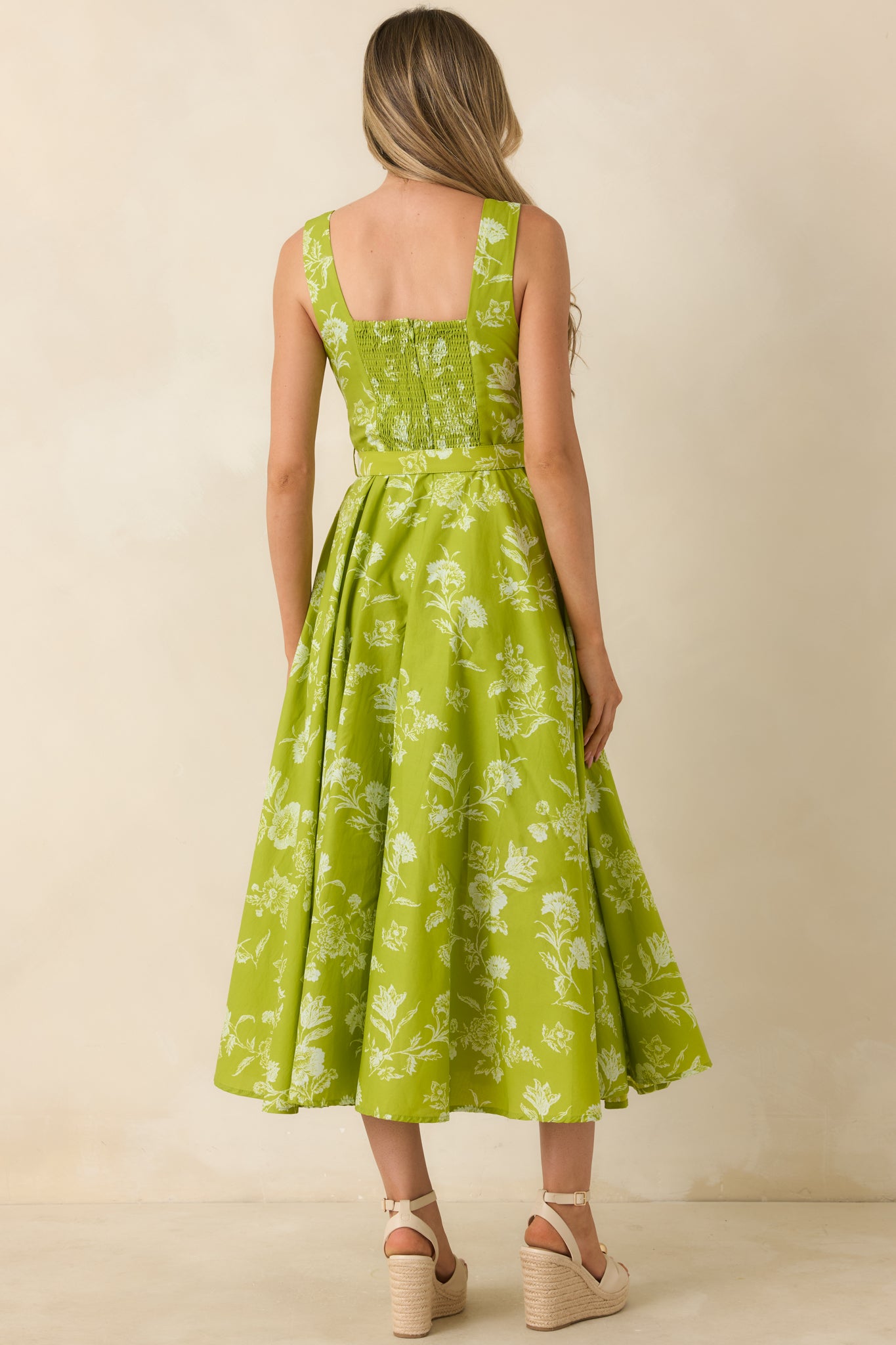 Rear view of the chartreuse floral midi dress featuring a smocked back panel, wide shoulder straps, and a full gathered midi-length skirt.