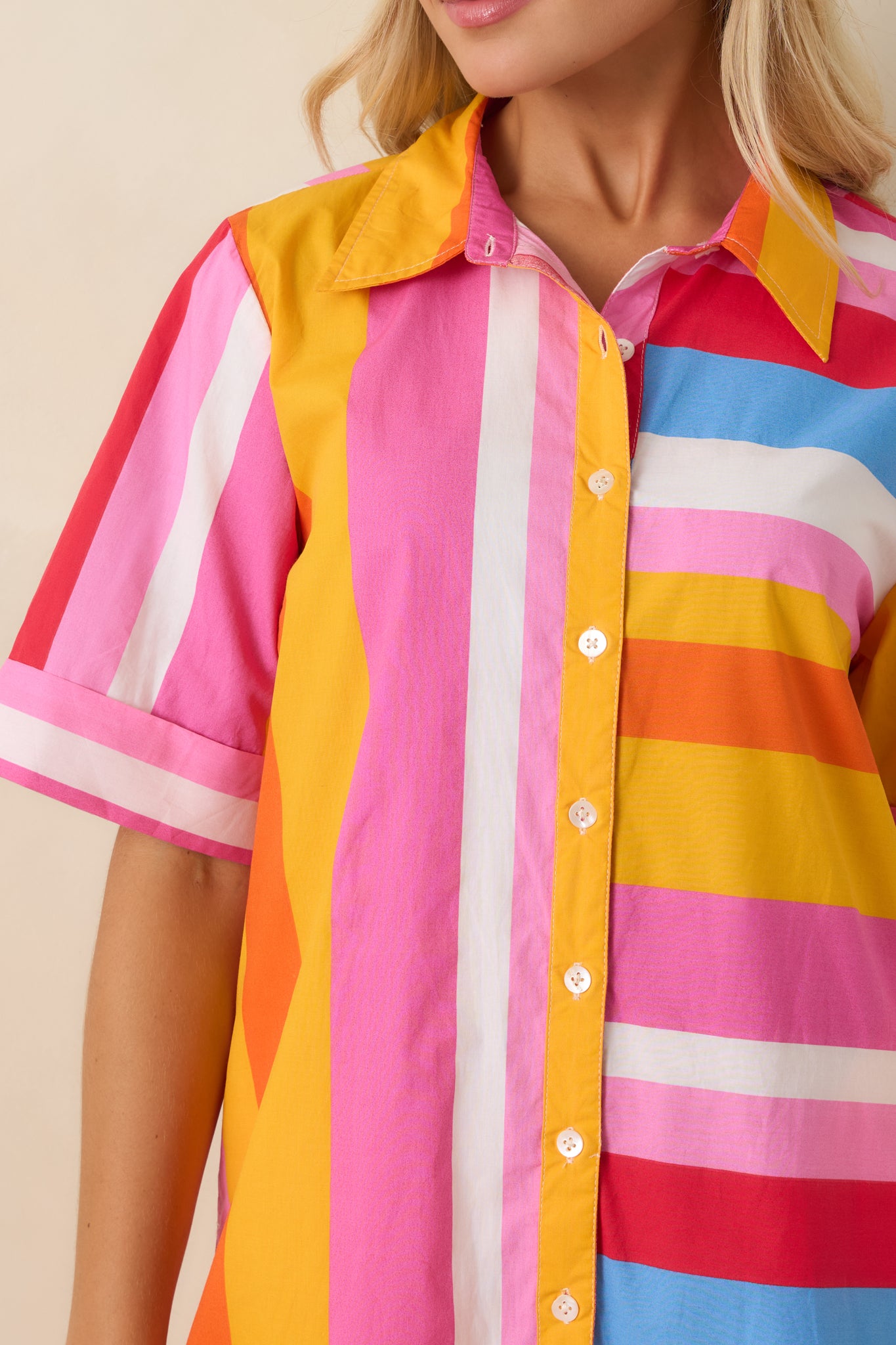 Detailed view of the multi stripe fabric, button front closure, and cotton texture on the shirt dress.