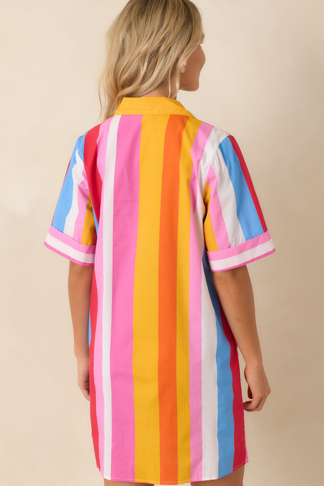 Rear view of the multi stripe shirt dress featuring a relaxed mini silhouette and short cuffed sleeves.

