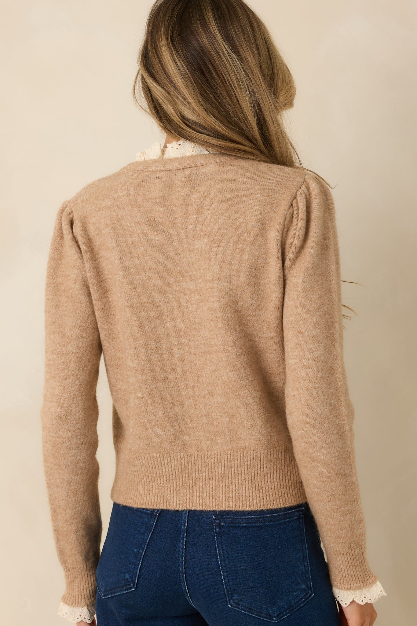 Rear view of heathered taupe knit cardigan with a clean V-neck shape and ribbed hem finish.