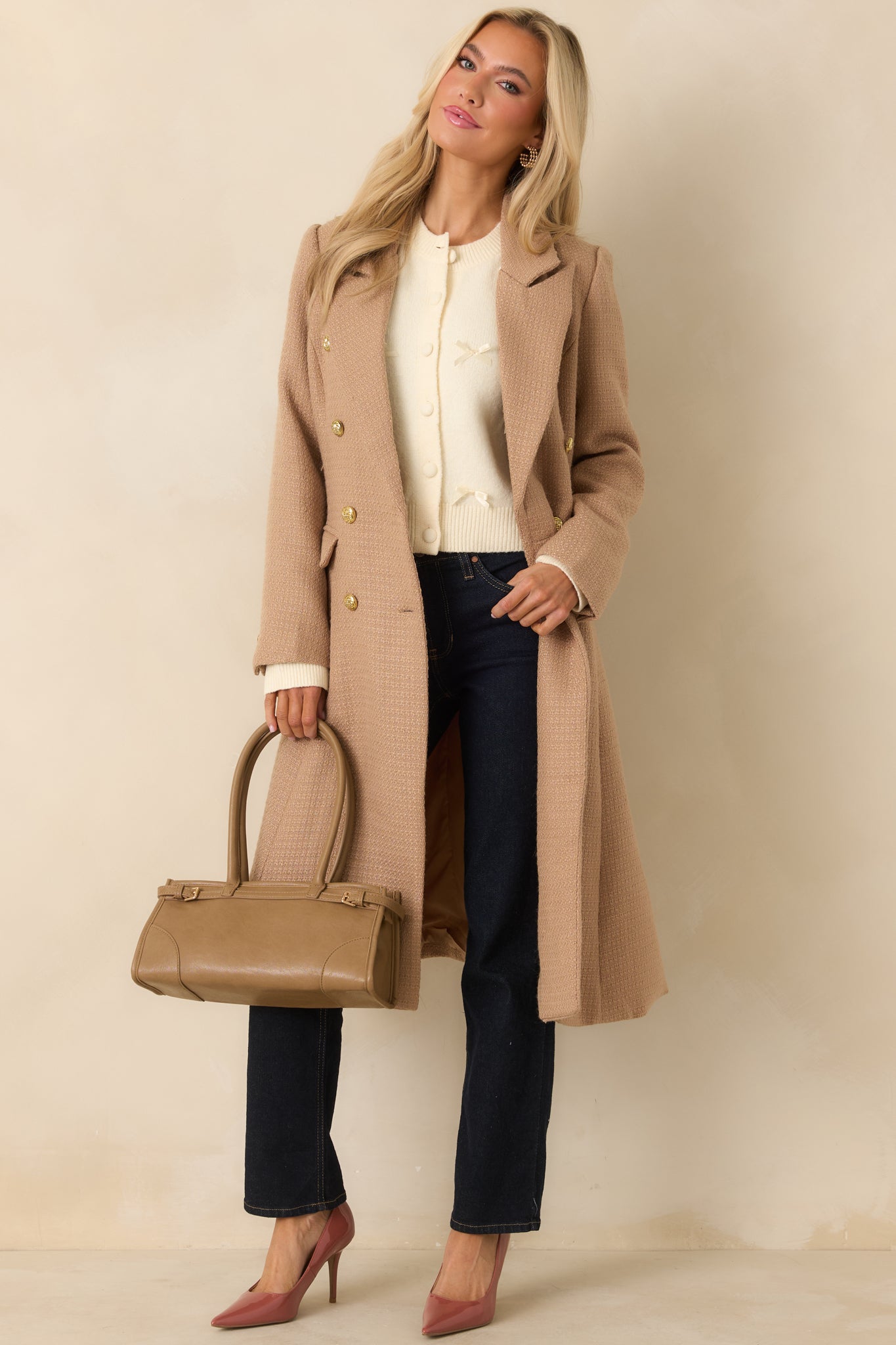 Full front view of the camel topcoat featuring a double-breasted silhouette and structured woven fabric.