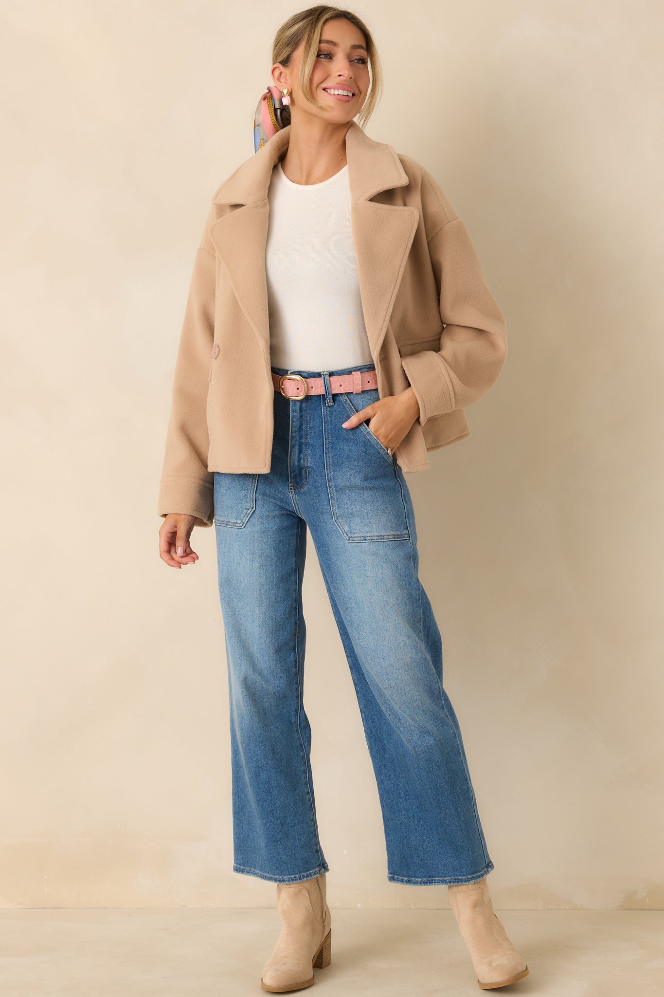 Taupe double-breasted jacket in brushed felted fabric with a clean notched collar and a soft, structured drape.