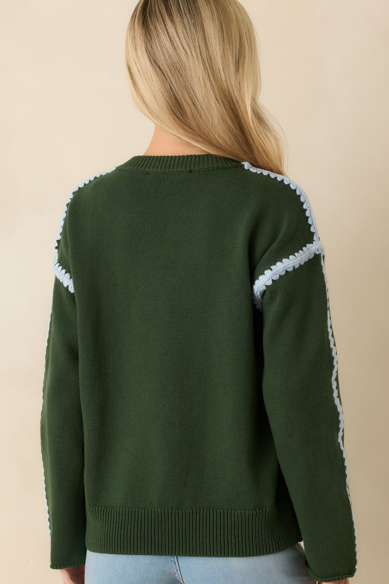 Rear view of the moss green sweater displaying a clean knit finish and ribbed neckline.
