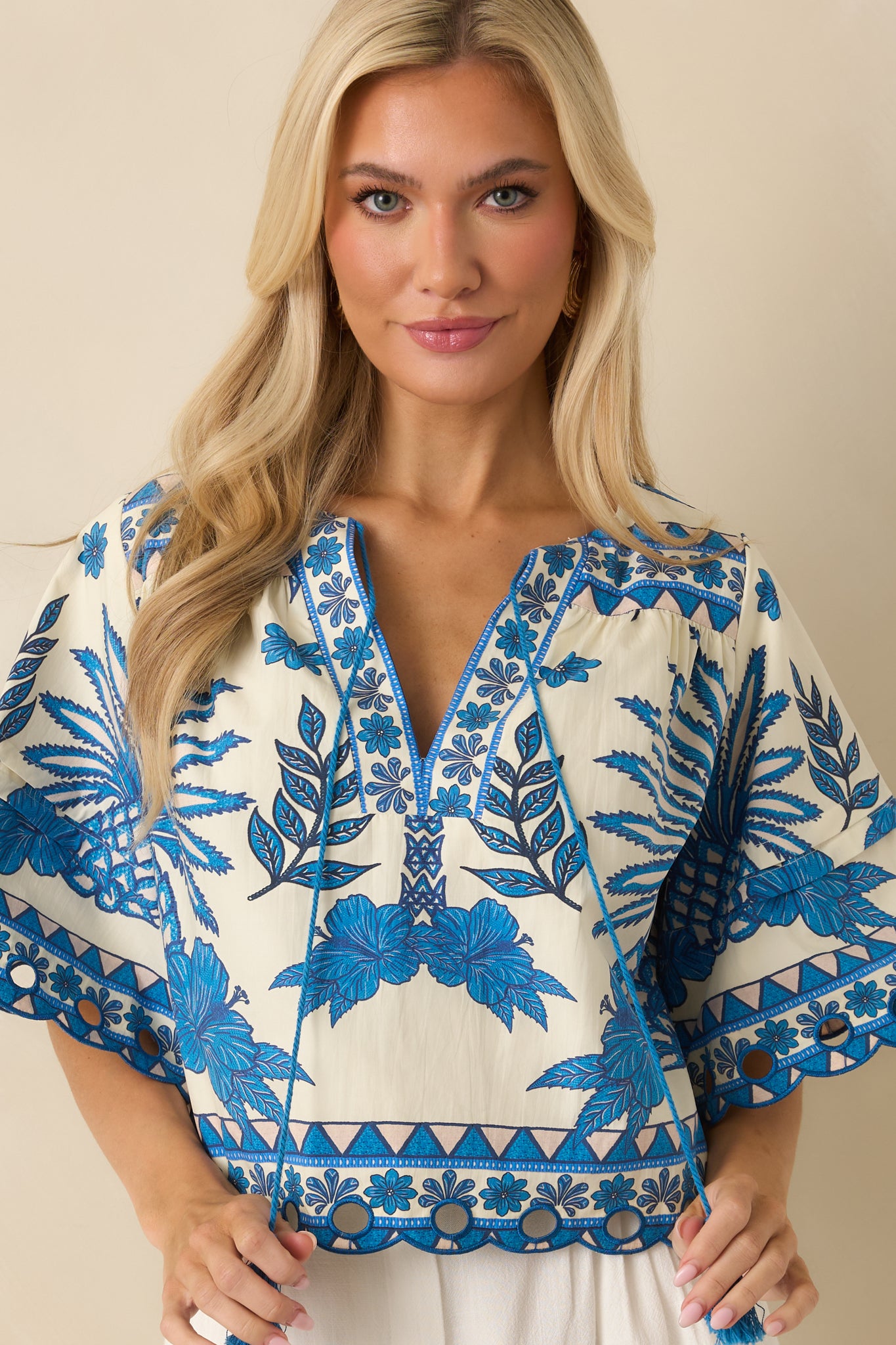 Close framing of the tropical-inspired print and smooth cotton texture.