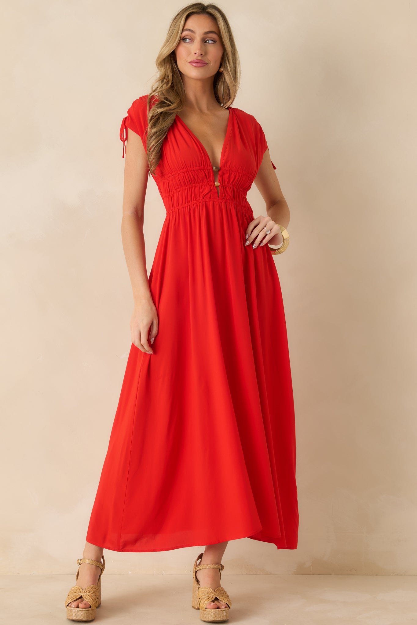 Flame-red midi dress with a plunging V-neckline and beaded detailing.