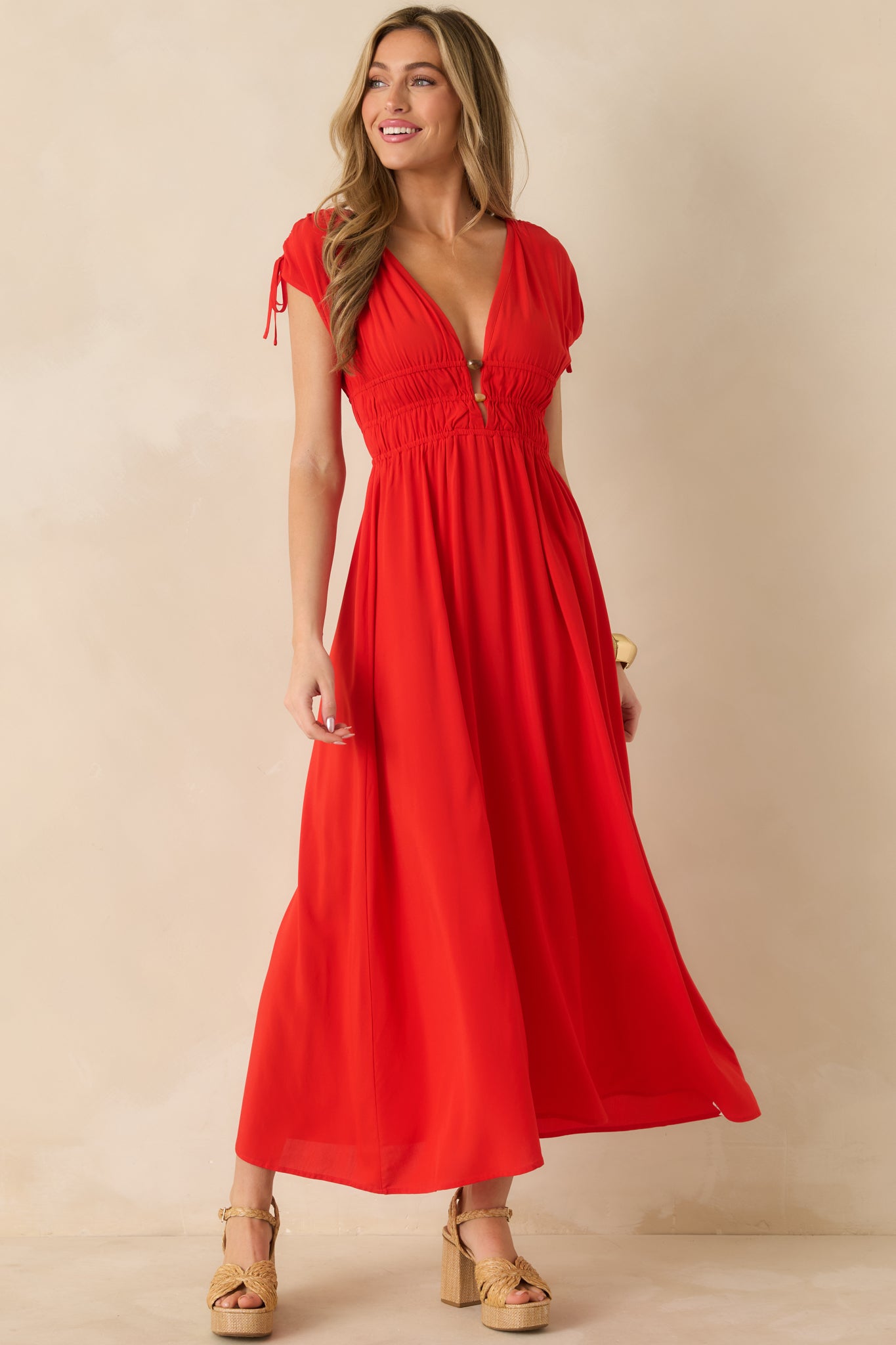 Lightweight woven midi dress featuring flutter sleeves and an elasticized gathered waist.