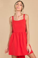 Front view of this dress that features a square neckline, adjustable shoulder straps, functional side pockets, and a zipper on the side of the dress.