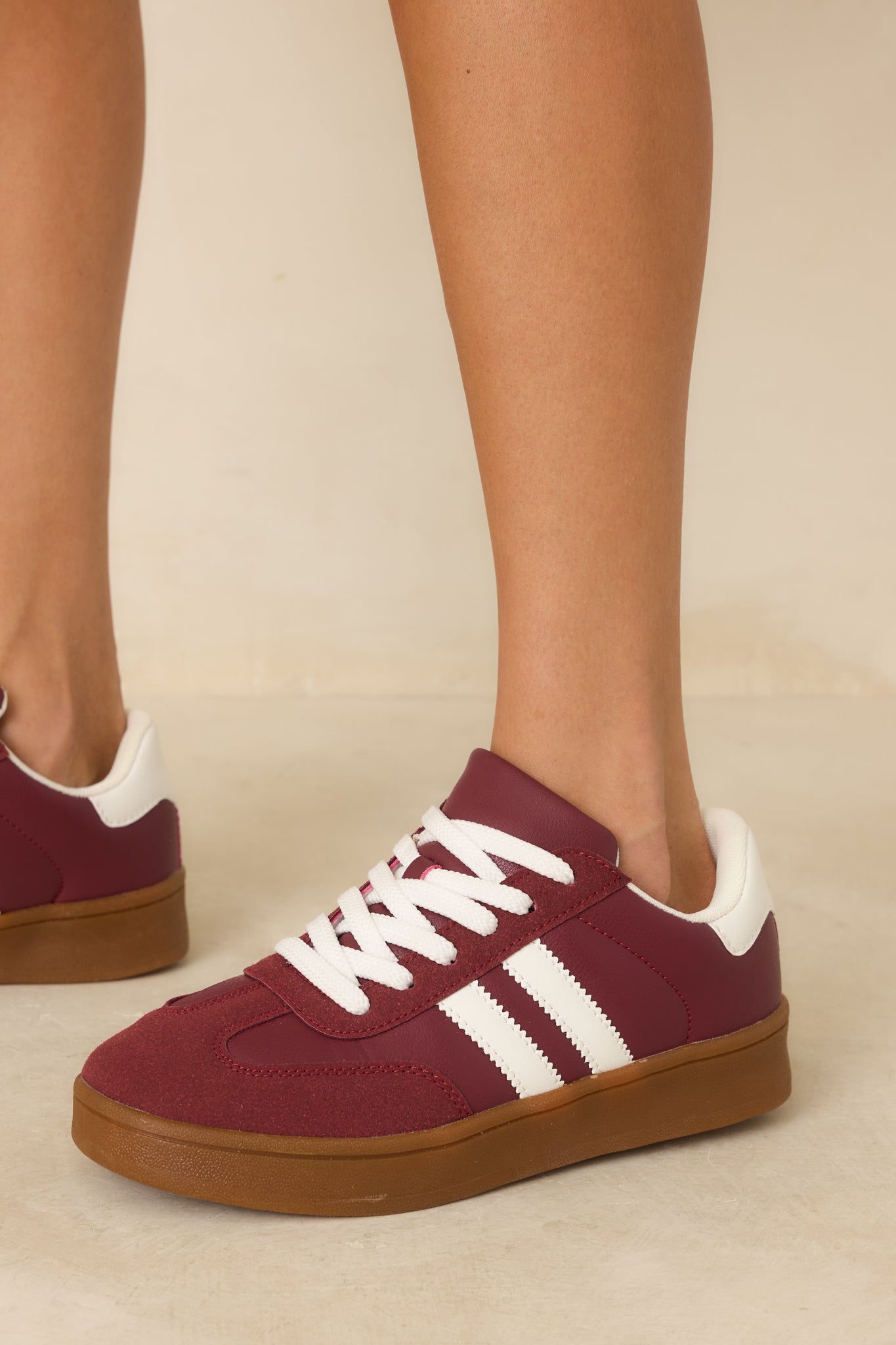 Close detail of the gum rubber sole paired with smooth synthetic paneling