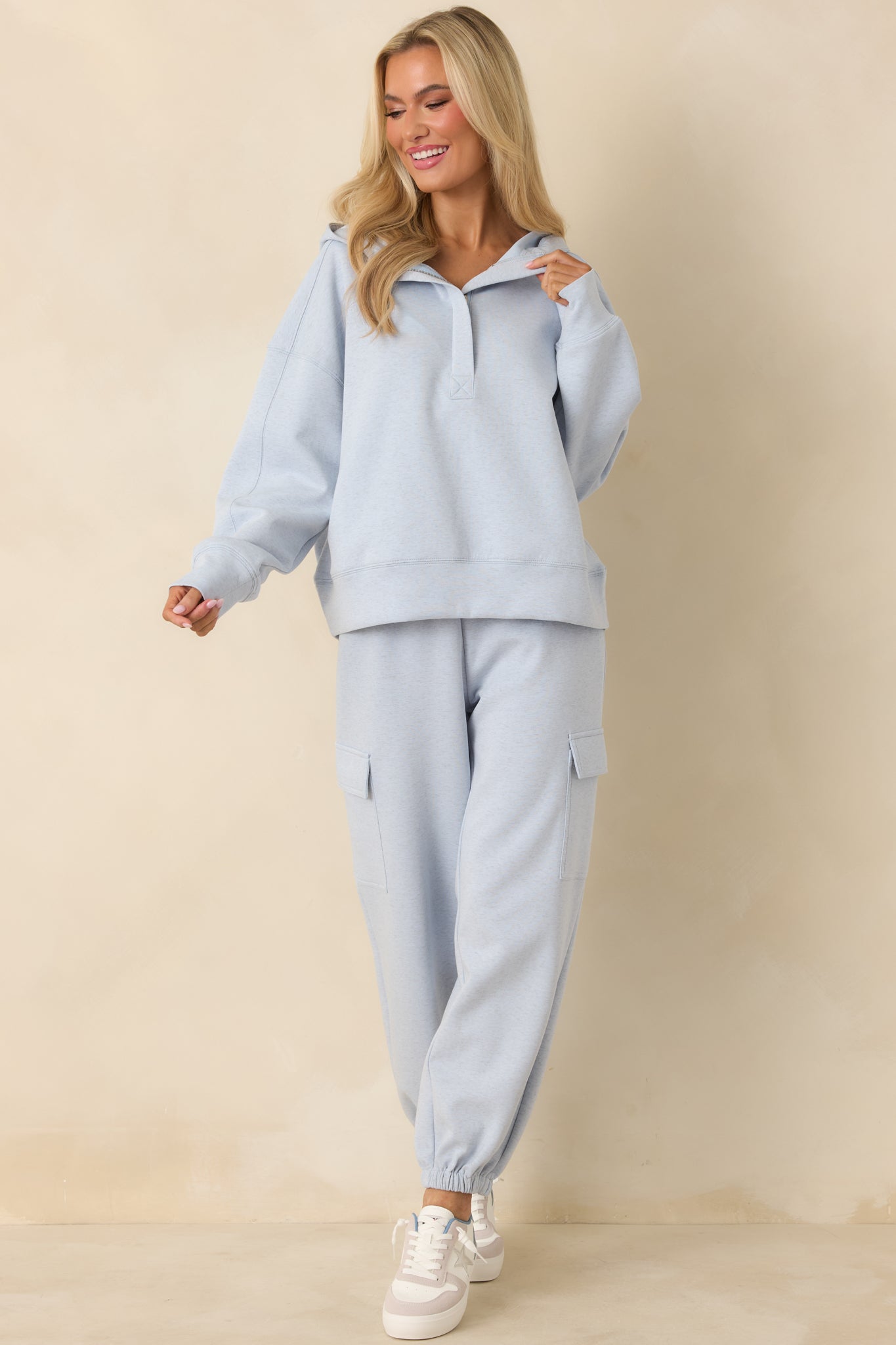 Front view of soft blue joggers featuring side cargo pockets and ankle cuffs.