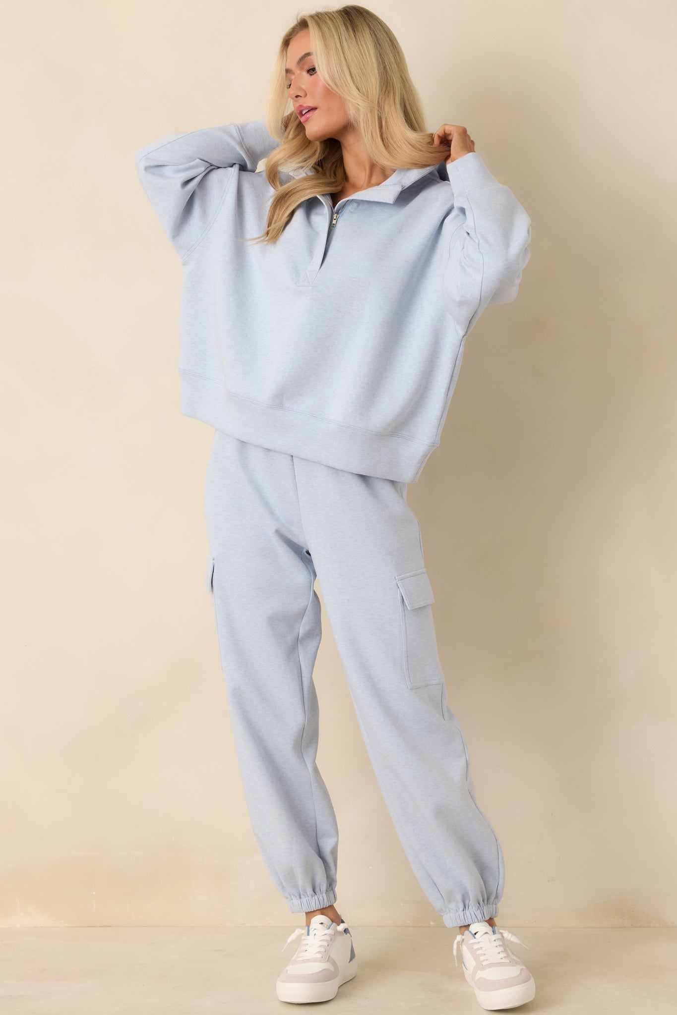 Light heather blue hoodie with partial zip neckline and soft sweatshirt knit fabric.