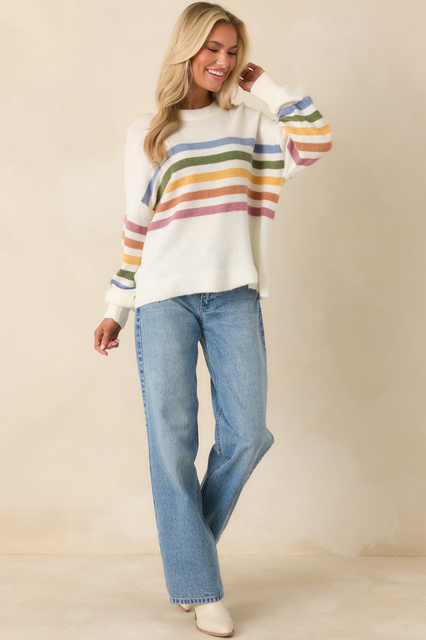 Ivory knit crewneck sweater with soft lightweight yarn and multicolor stripe detailing.