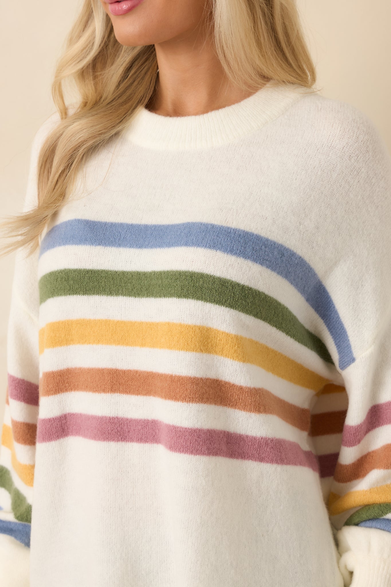 Soft lightweight ivory knit texture shown up close with multicolor stripe contrast.