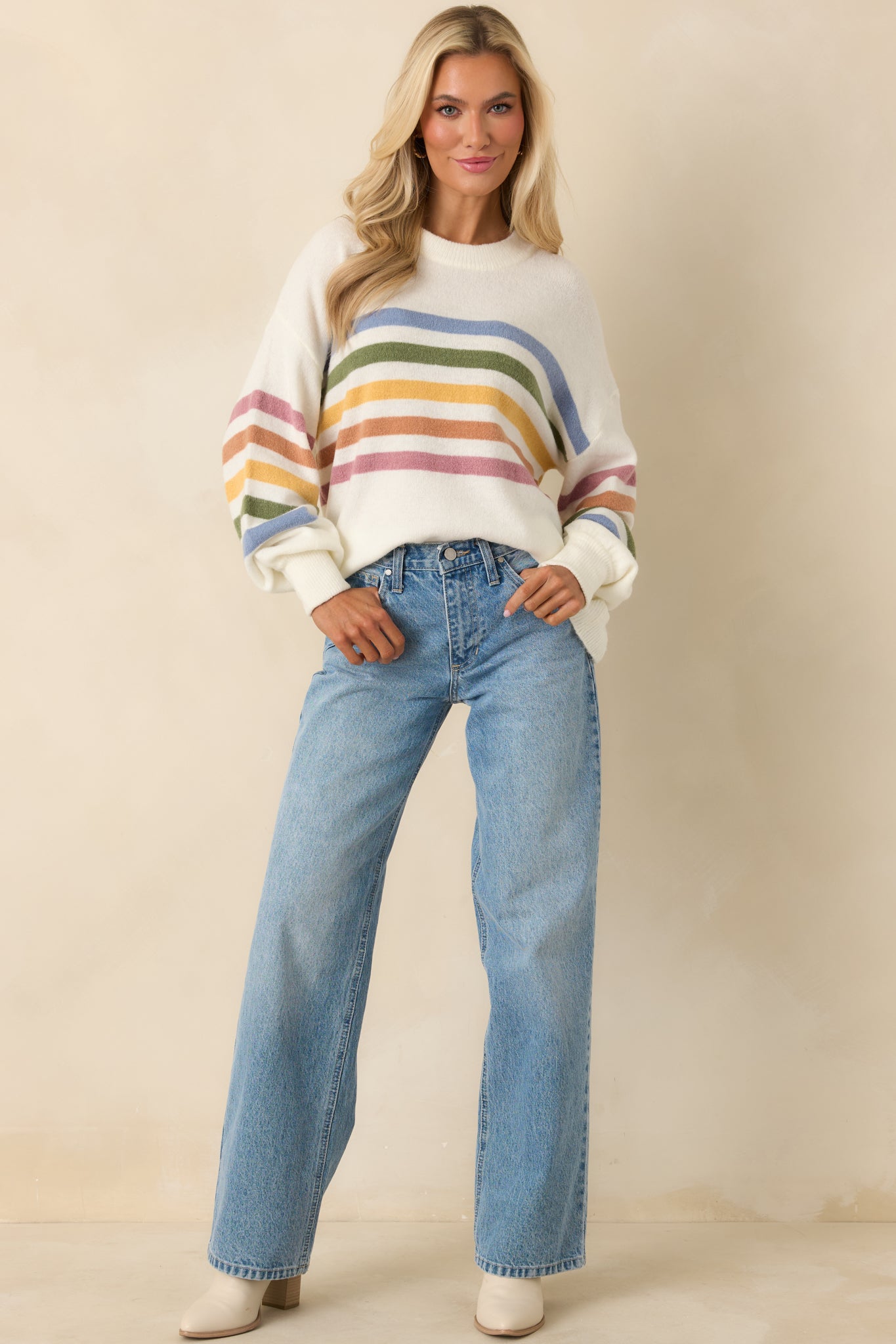 Lightweight ivory knit sweater featuring ribbed neckline and relaxed everyday fit.