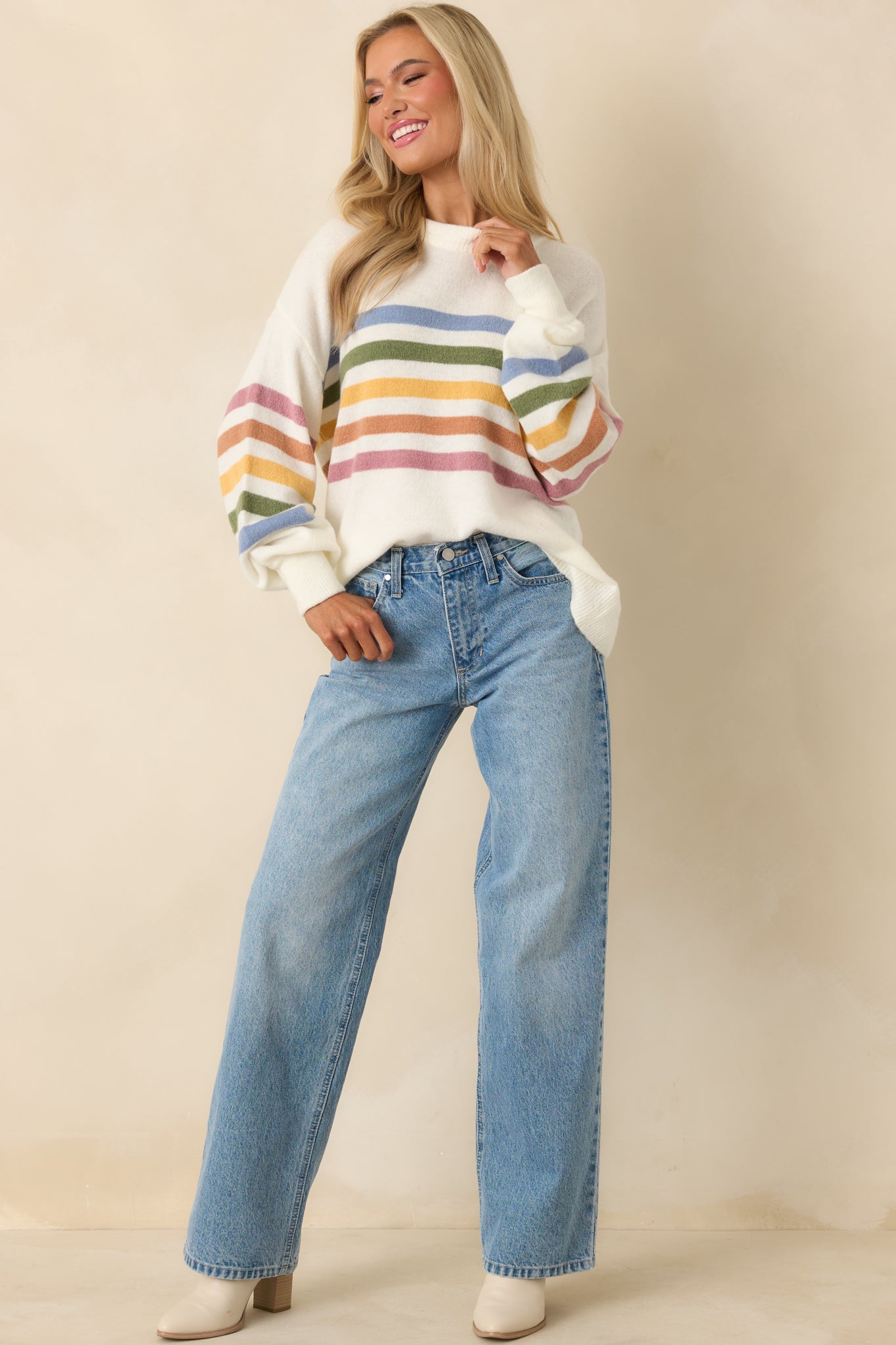 Ivory striped sweater with ribbed cuffs and clean straight-hem finish.