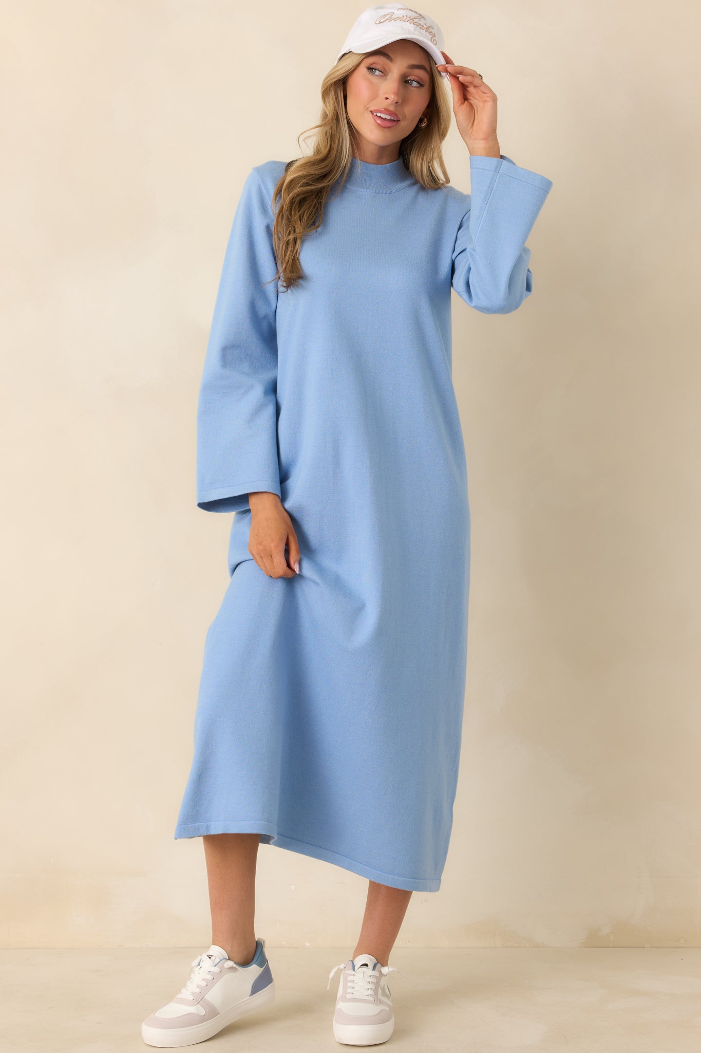 Soft light blue knit midi dress with a sleek column shape and minimalist design.