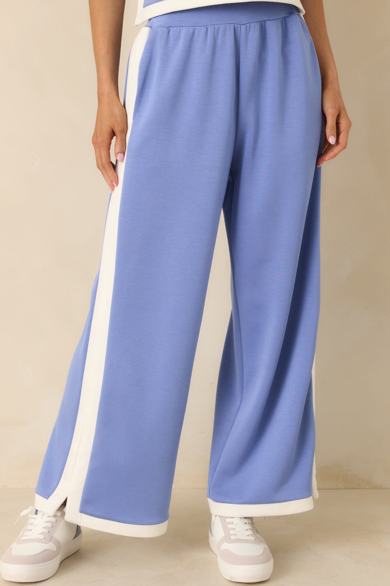 Periwinkle stretch knit fabric with crisp contrast trim along the side seam.