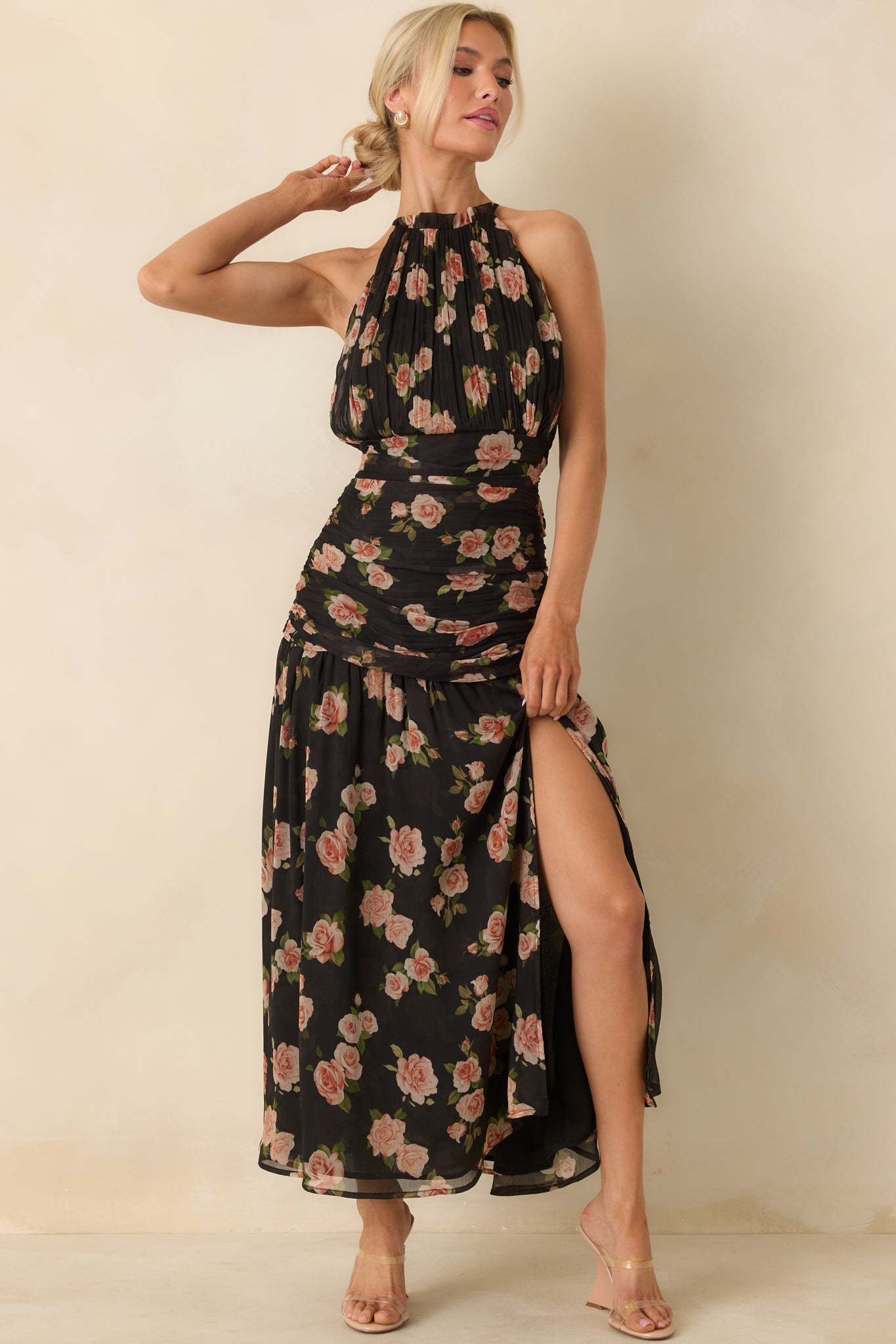 Black chiffon halter maxi dress with pastel floral print and a relaxed, floor-length drape.