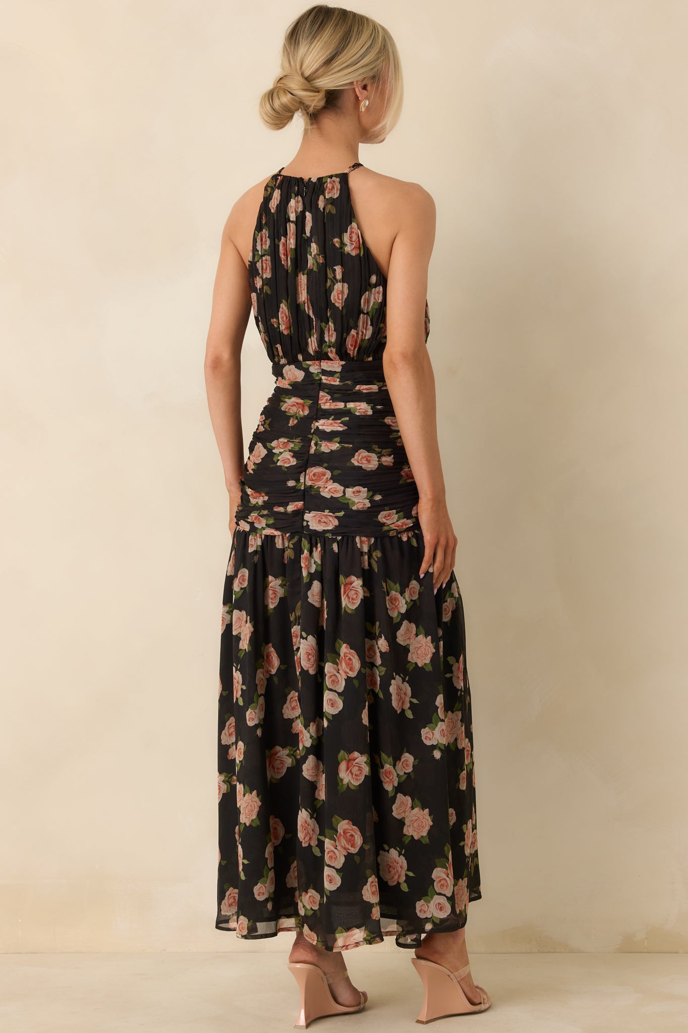 Rear view of black halter maxi dress showing the gathered neckline and smooth lined body finish.