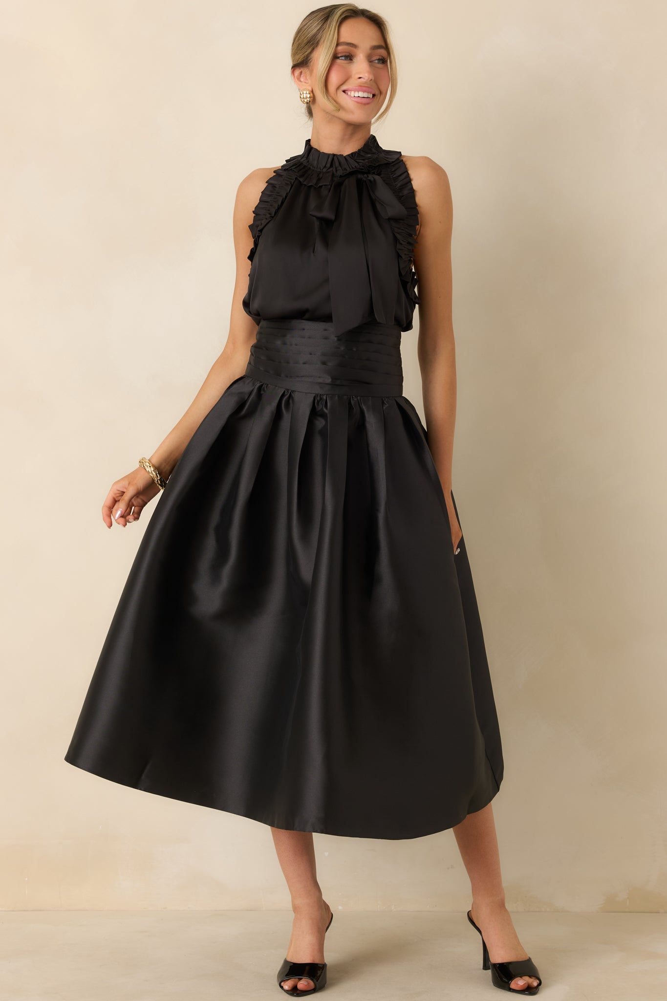 Full-length black skirt with a structured waistband, pleated details, and fully lined interior.
