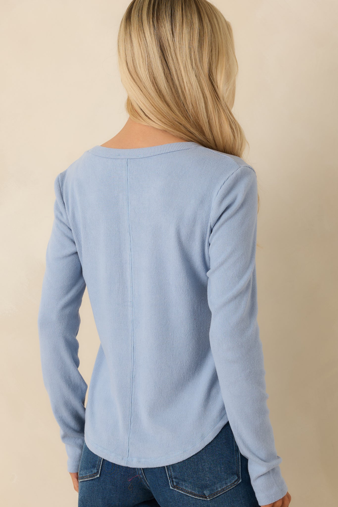 Rear of the sky blue long-sleeve henley showing smooth ribbed knit fabric, straight hem, and relaxed fit.