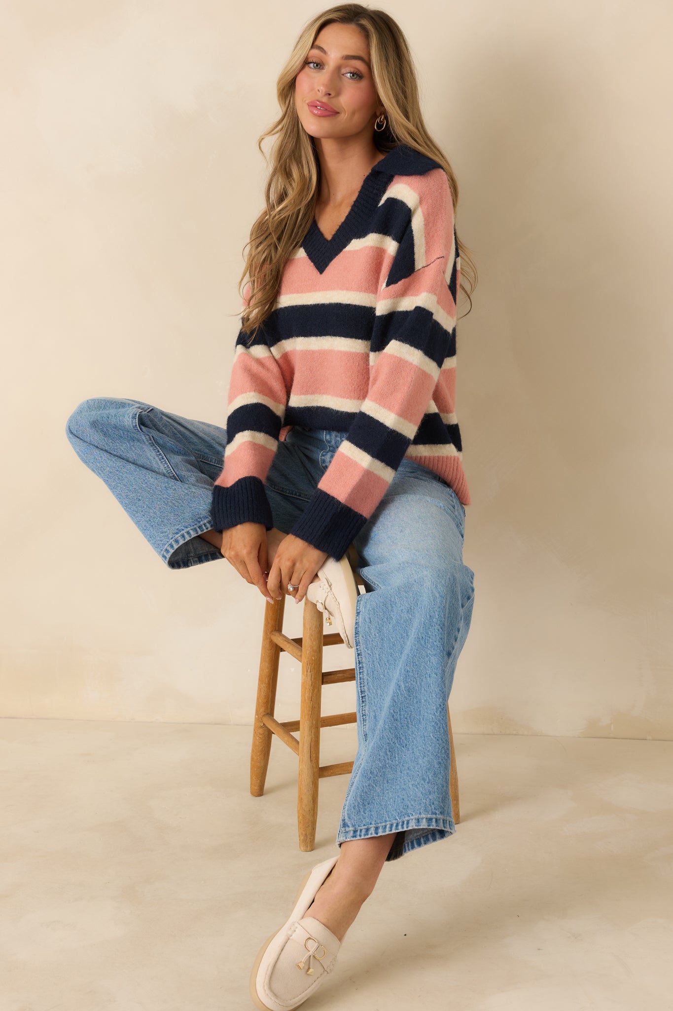 Striped brushed knit sweater featuring navy, mauve, and cream horizontal stripes with a V-neckline and collar detail.