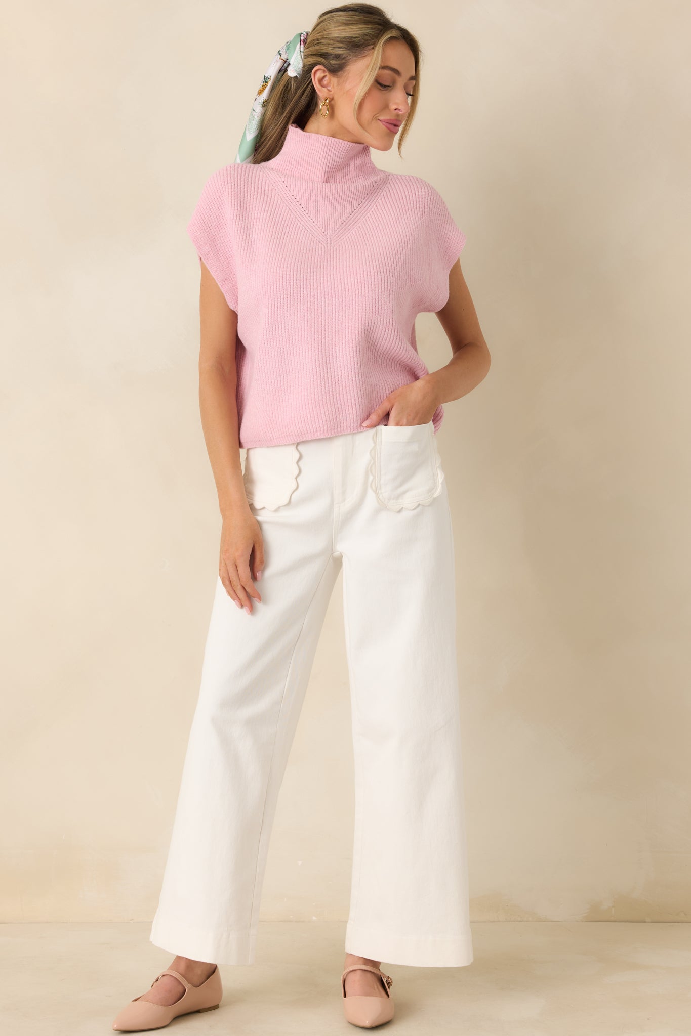 Full front view of ivory high-rise cotton pants with wide leg silhouette and front button closure.