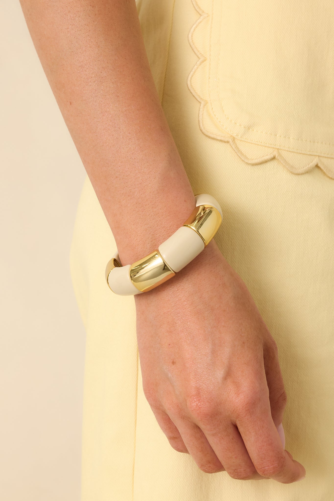 Close view of the ivory and gold beads showing the smooth surface and alternating color pattern.