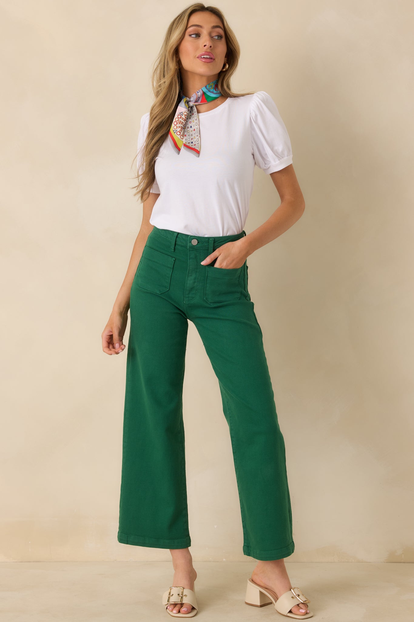 Green denim jeans designed with a structured high waist and a bold, roomy wide leg silhouette.