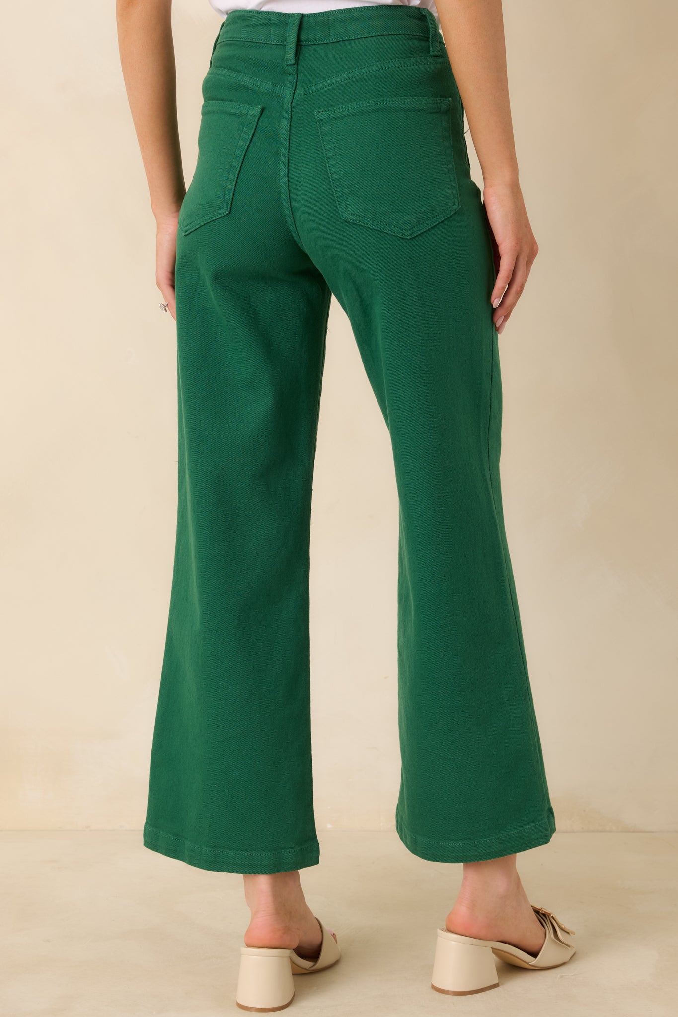 Green denim jeans with rear patch pockets and a wide leg cut that keeps the look laid-back and timeless.