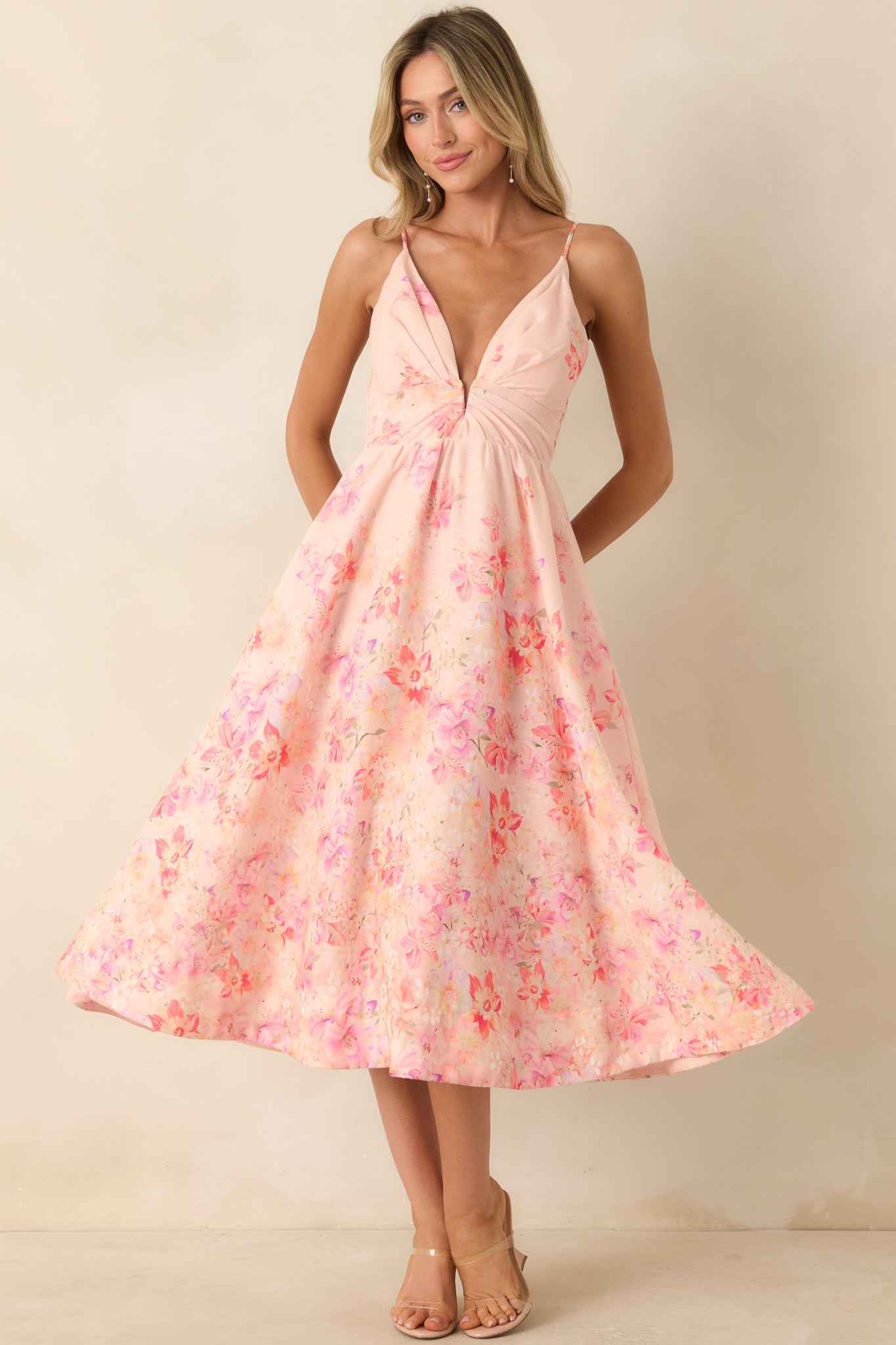 Pink floral dress with a smocked elastic back panel and a softly flared midi-length skirt.