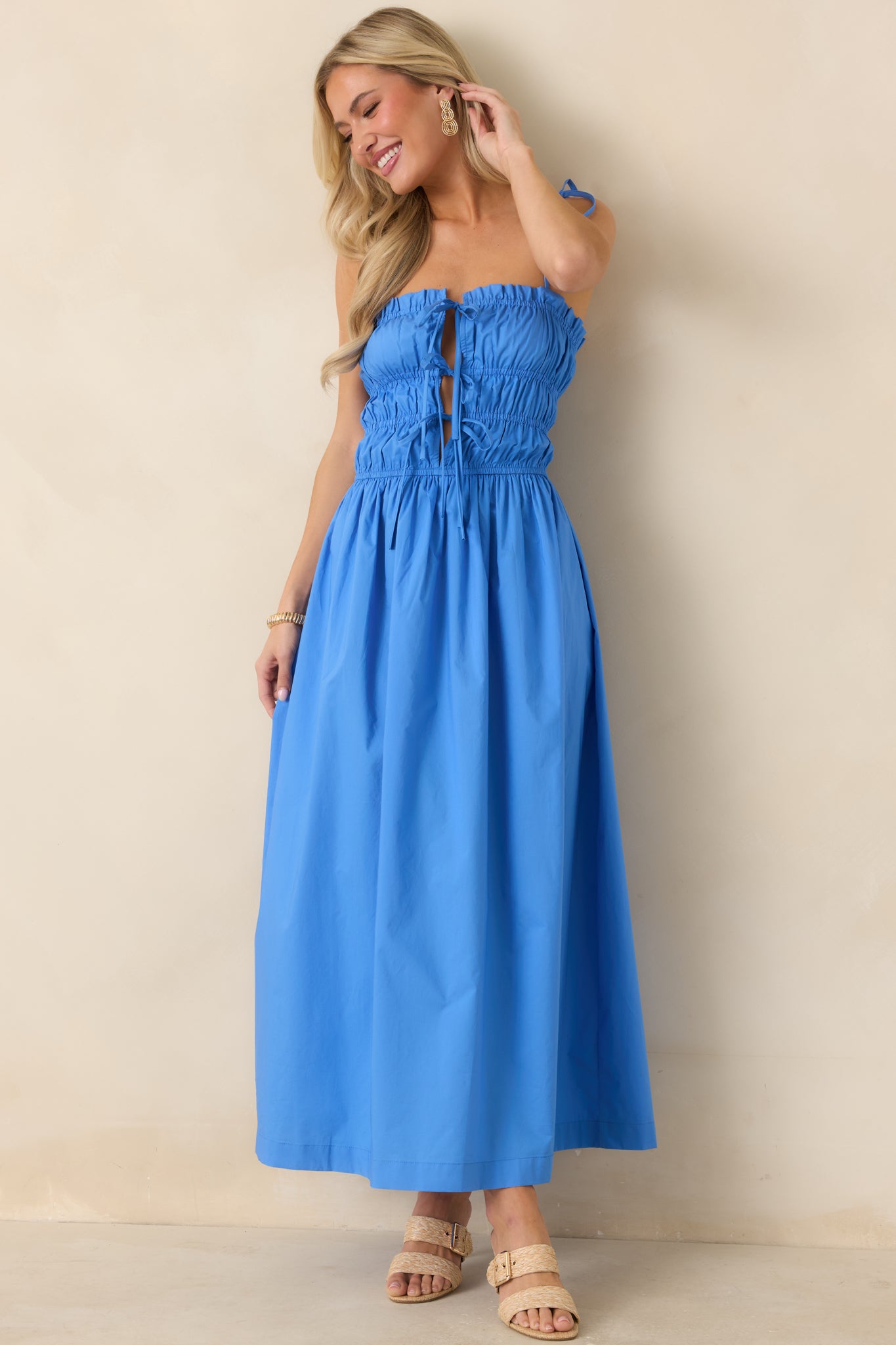 Ruched midi dress with softly structured bodice and adjustable tie-front detailing.