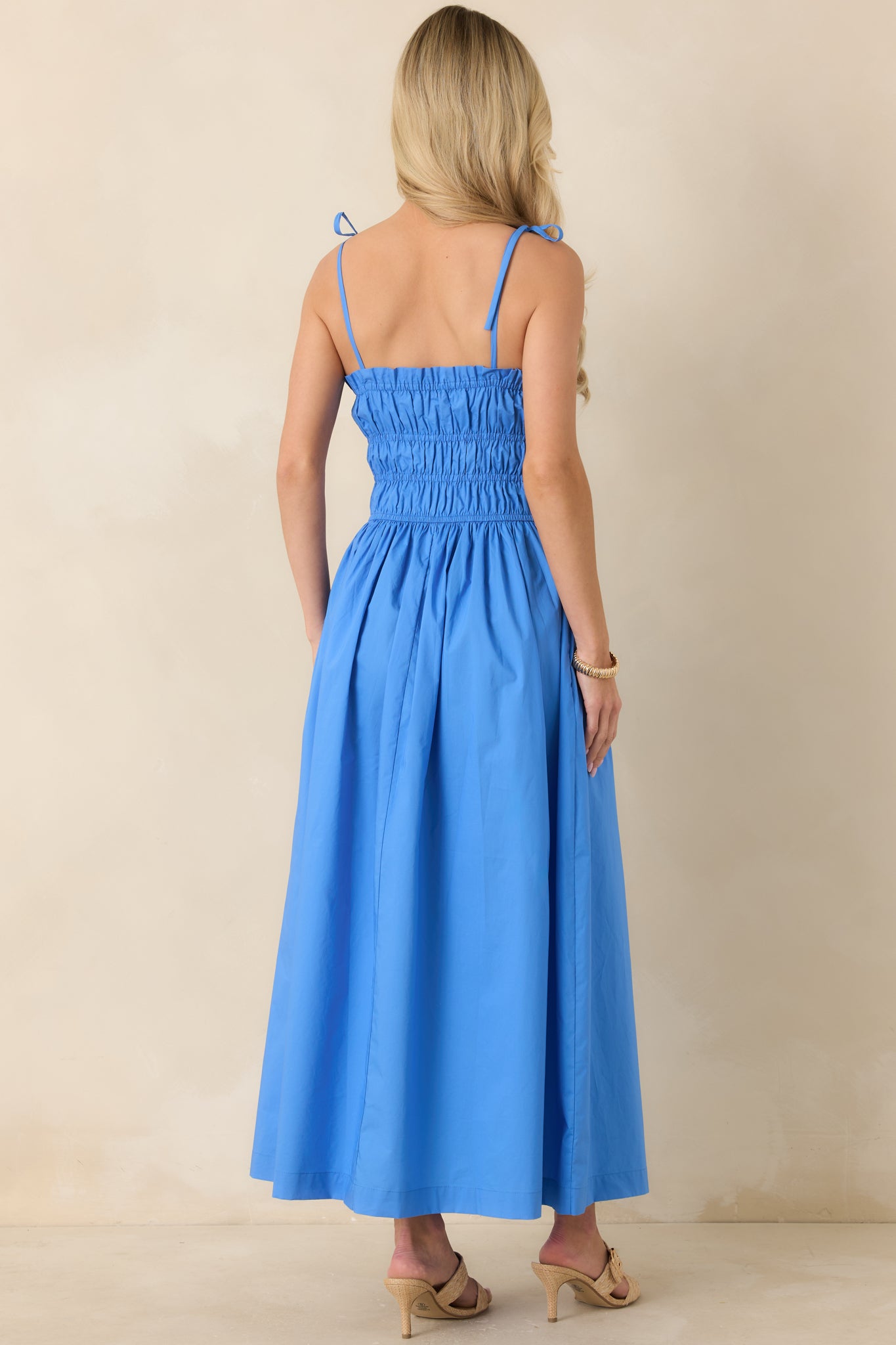 Rear view of midi dress with open-back design and delicate shoulder tie straps.