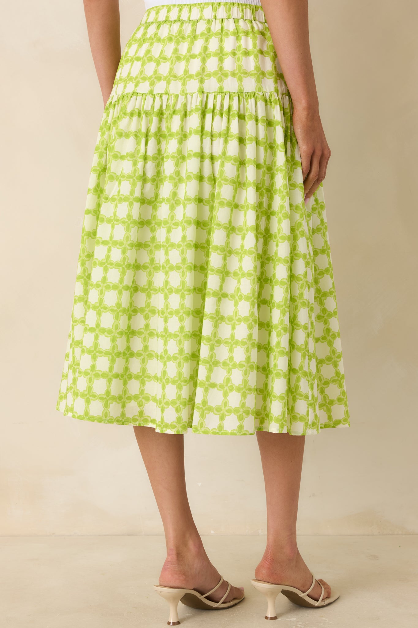 Rear view of cotton skirt with cinched waistband and full gathered silhouette.