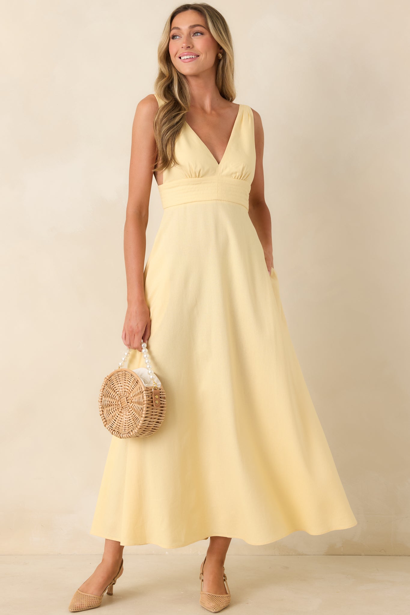 Deep V-neck midi dress with wide shoulder straps and structured waistband.