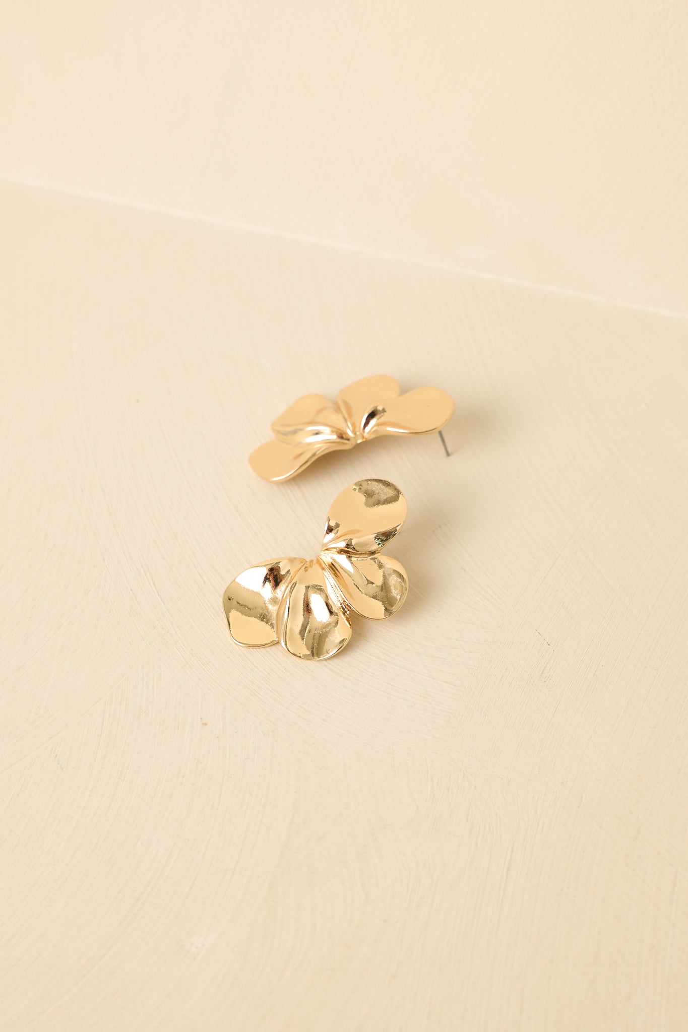 Tight cropped angle focusing on layered flower-inspired design and smooth metal texture.