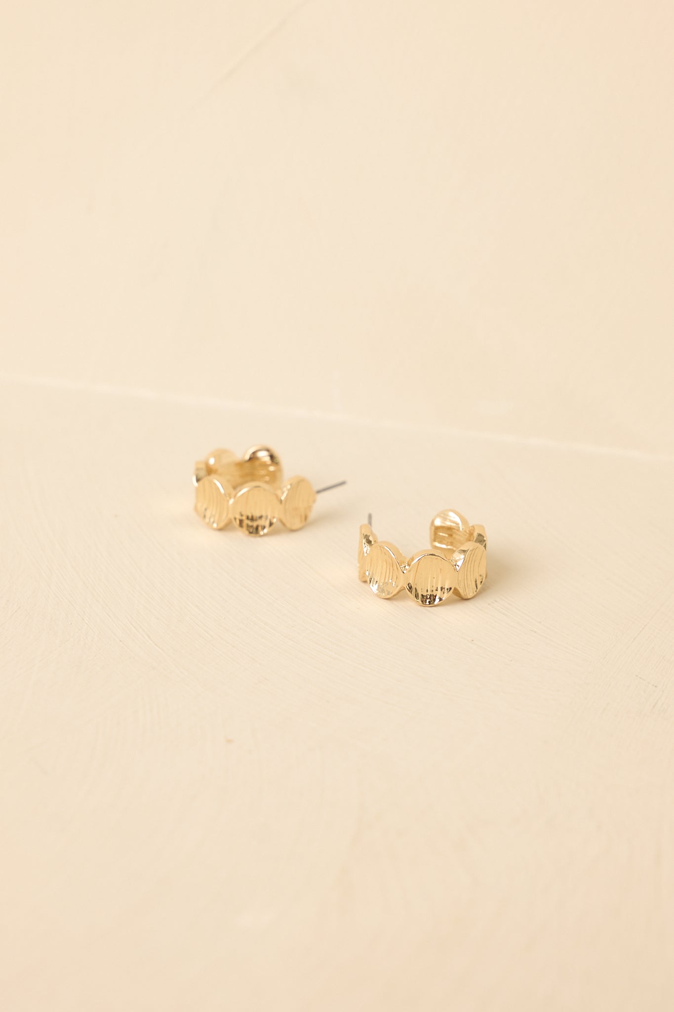 Tight cropped angle focusing on rounded shape and polished gold finish.