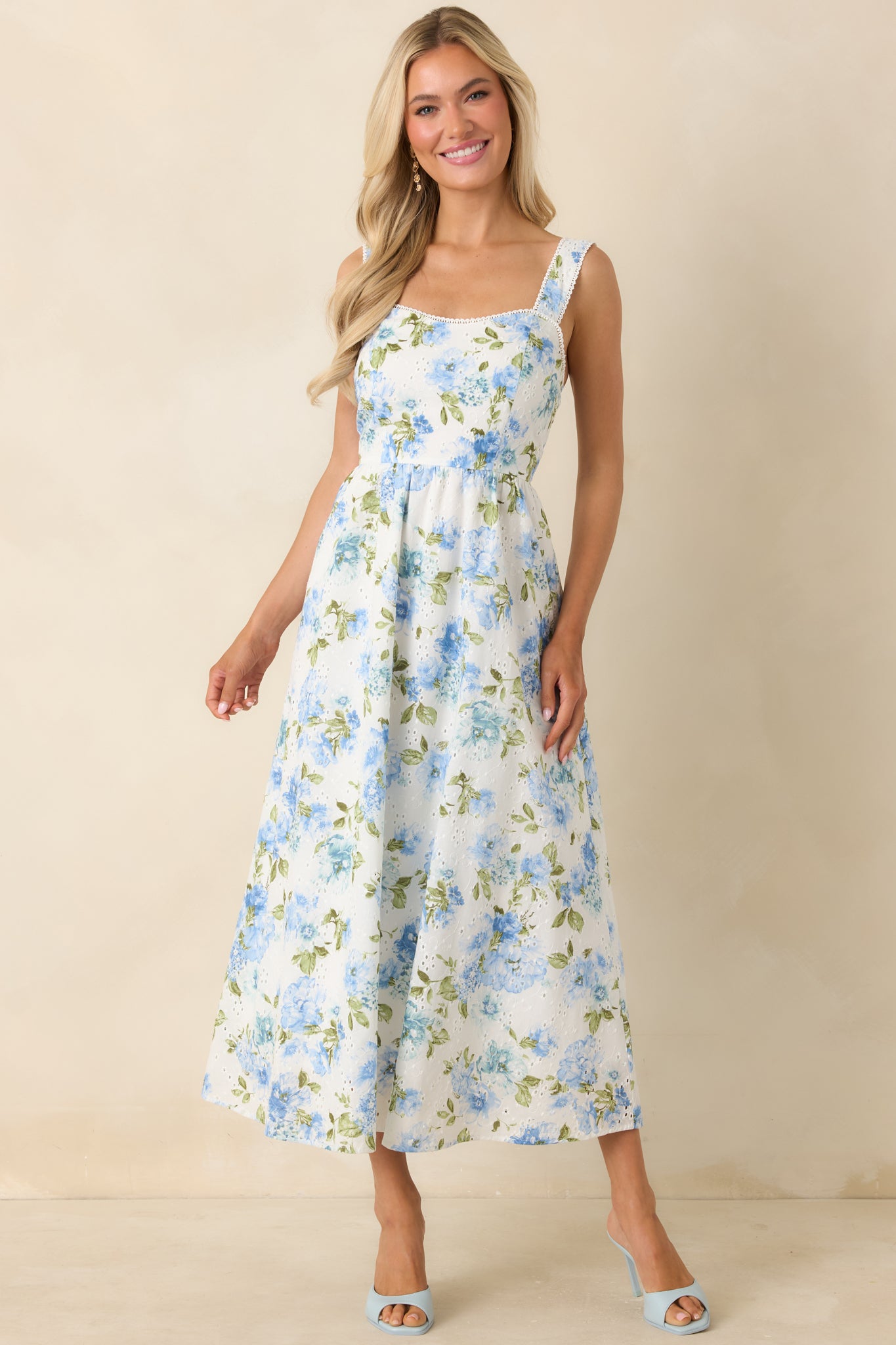 Eyelet cotton midi dress with adjustable straps and gently flared, flowing shape.
