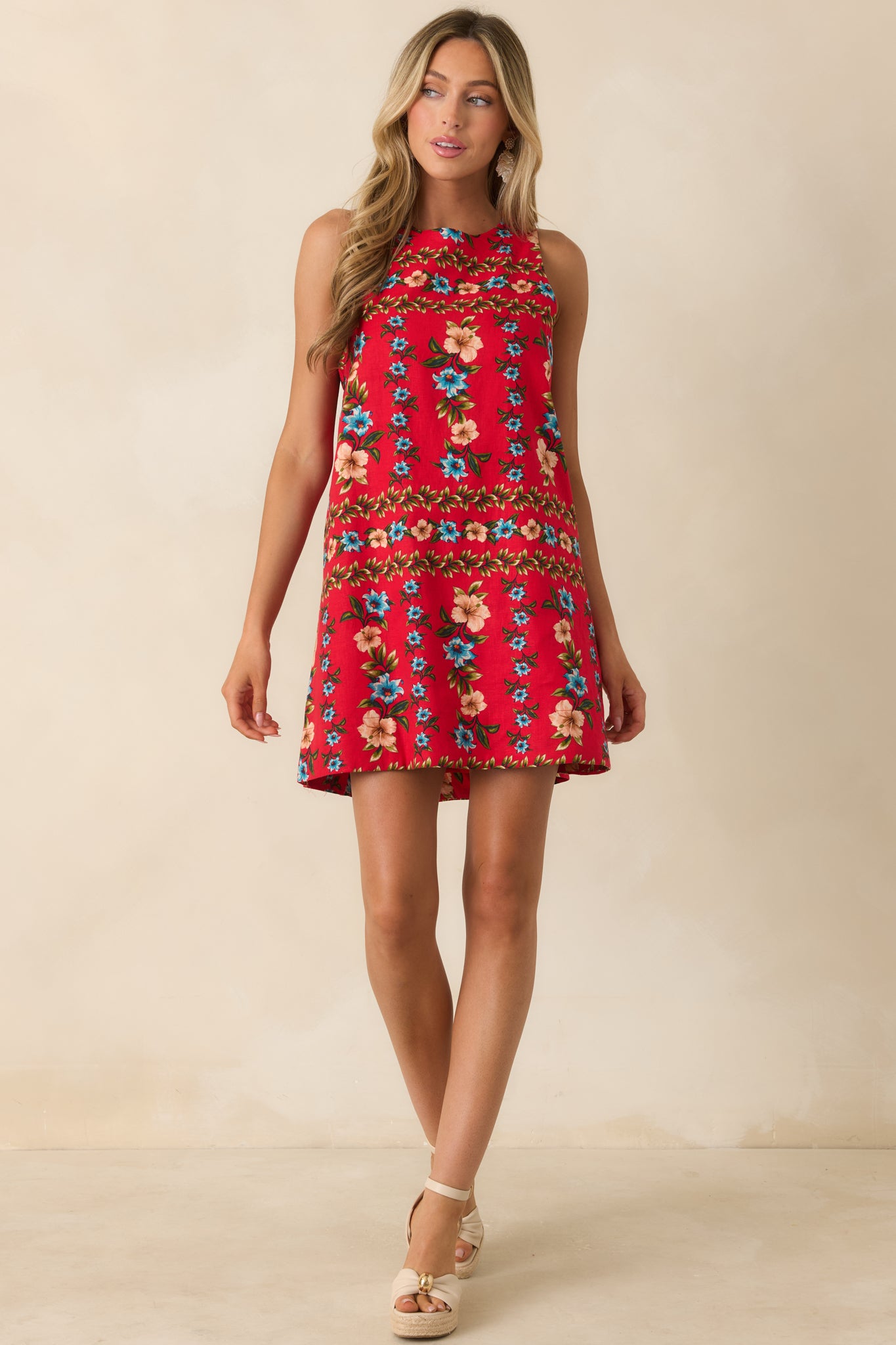 Lightweight linen blend mini dress featuring a vibrant floral print and relaxed, flattering silhouette.