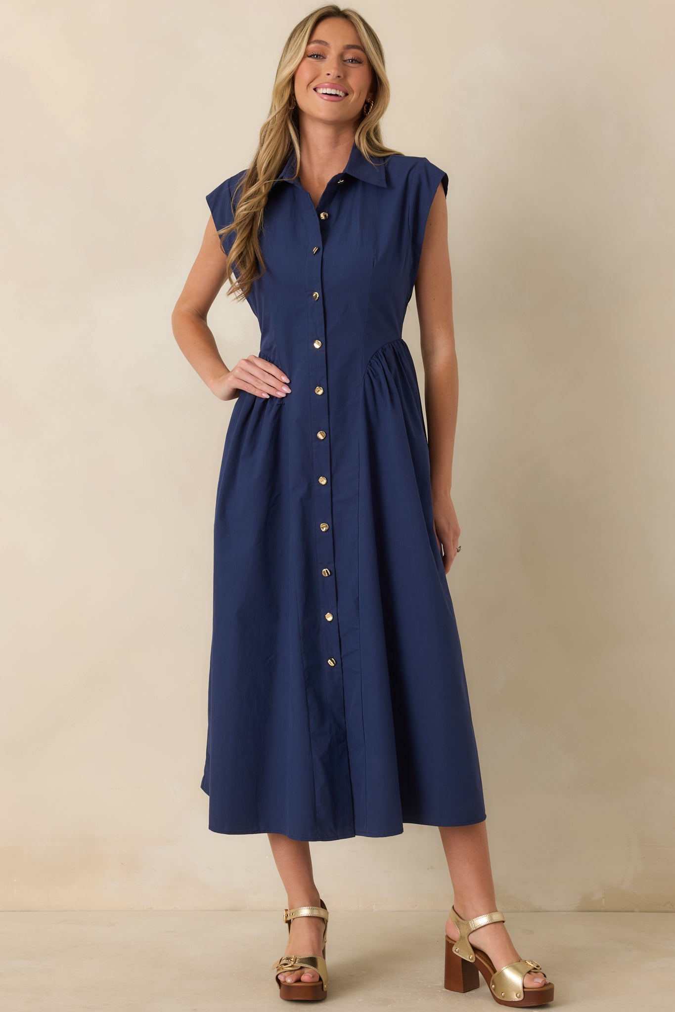 Classic navy cap sleeve dress showcasing a collared neckline and flattering midi-length silhouette.