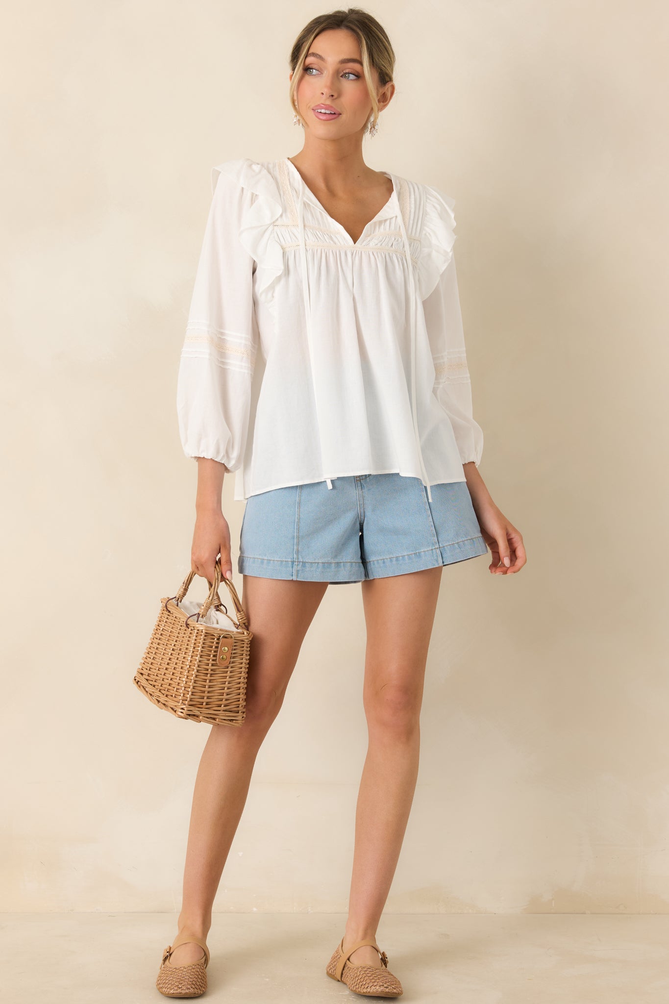 Relaxed white blouse with airy fit and romantic lace and ruffle accents.