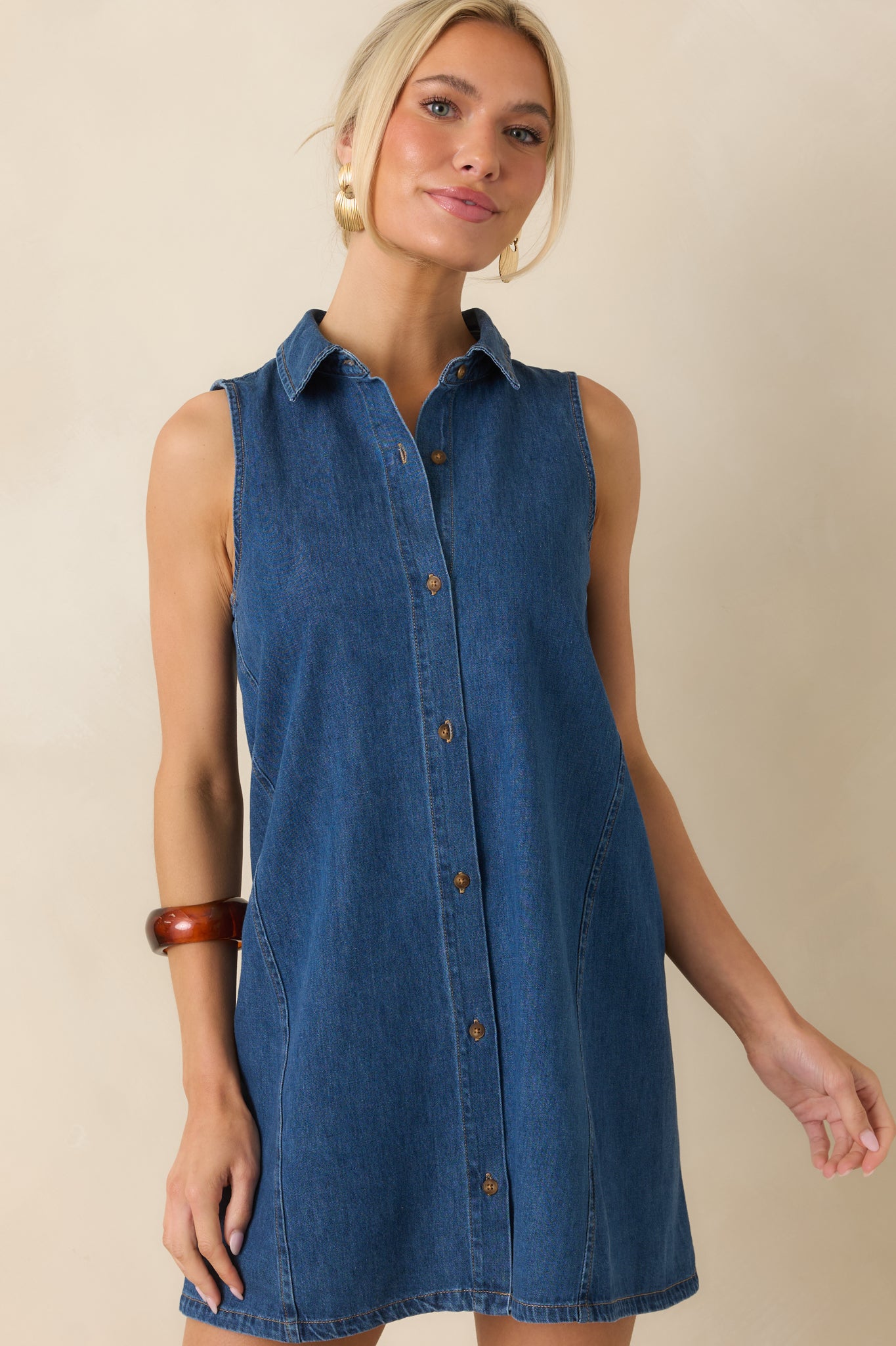 Front detail highlighting the subtle contrast stitching across the dark wash cotton denim fabric.